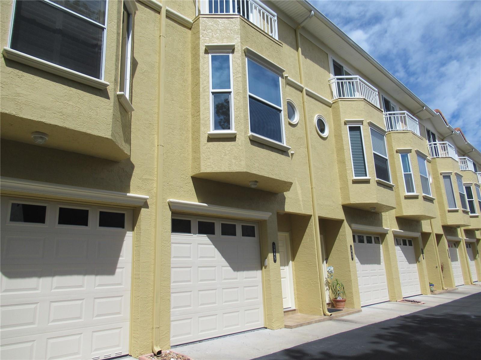 Welcome to Tierra Sound, a Tierra Verde Town Home with a spacious coastal feel, neutral decor & 2236 sq. ft of well-planned space with a TWO CAR TANDEM garage! Beautiful hand scraped look darker bamboo flooring throughout the living level (2018). Latest updates include new AC main level 2024, new upstairs AC (2023) including air scrubber UV light, new H20 (2024), newer high impact windows in the kitchen (2018) and newer impact patio doors in BR #2 (2018). Updated kitchen (2018) with granite counters, quiet-close cabinetry with extra tall cabinets and double width drawers, Whirlpool stainless appliances and lighting. Sunny breakfast nook great for small table, or sit at the granite counter. Enjoy the convenience of a half bath on the living level. Dining area will hold good size furniture as well. The large living room has a coastal feel tile surrounding the wood-burning fireplace. Wall TV mount already hooked up and ready! Triple sliders out to screen-enclosed tiled balcony overlooking green space. Huge Primary Suite with en suite bath featuring spa tub and separate shower, double sinks and updated vanity & top (2018), plush carpeting, high ceilings, and two walk-in closets. BR #2 has private en suite bath, plush carpeting and balcony with newer impact doors. Washer-Dryer ideally located on bedroom level. BR #1 on first level has it's own private bath and new beautiful 7" wood plank coastal look waterproof laminate flooring and walk-out to covered porch to the grounds/pool. This bedroom is excellent use of space for guests, den or home office. Heated swimming pool, spa and tiki hut for your use. Water/sewer/garbage/cable tv, Internet & WiFi included in the monthly HOA fee. Homeowners and flood insurance are separate from monthly HOA fee. Flood policy is assumable. Complex just finished new roof August 2025. Pets allowed max weight 30 lbs per pet. Additional outdoor parking spaces for building 2. Slip may be available for purchase or lease through another owner. Just across the street enjoy "Downtown Tierra Verde" with restaurants including Billy's Stone Crab & multiple businesses. Further down the road is Ft. DeSoto known for its pristine beaches, dog beach, camping, picnic areas with grills, boat ramps, hiking/biking trails and fishing pier. Don't miss this fabulous opportunity to own a spacious and well-maintained move-in ready beautiful town home at Tierra Sound!