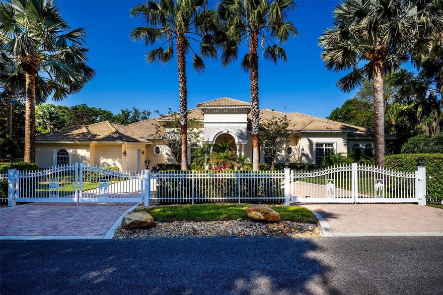 Discover an extraordinary LAKEFRONT retreat in the heart of Lake Mary! This stunning 4-bedroom, 4-bath custom home boasts an INFINITY POOL and sits on a PRIVATE peninsula with sweeping, panoramic views of Big Lake Mary—a true rarity. Embrace the lifestyle you’ve always dreamed of in this 5,000 sq.ft. paradise, crafted with exceptional quality and built to exceed Orlando-area structural and hurricane standards. 
Step through custom double iron doors into a world of architectural elegance: soaring arches, coffered ceilings, crown molding, and expansive windows frame breathtaking water and pool vistas. The open-concept design flows seamlessly, featuring a sophisticated office with high-end built-in cabinetry, a spacious formal dining room, and a living room with a cozy fireplace. The heart of the home is a newly remodeled gourmet kitchen with a massive waterfall island and dinette area, overlooking the expansive 26x23 family room featuring panoramic outdoor water views —and perfect for game nights or movie marathons.
The thoughtful 3-way split bedroom layout includes a luxurious owner’s suite with spacious en-suite bath and generous closet, plus two additional bedrooms with private baths. But the real showstopper is the outdoor lakefront OASIS: a covered porch with a TV, fireplace, built-in grill, stone accents, and a 40’ lighted, retractable awning. Dive into the stunning infinity pool with three waterfall fountains, unwind on the expansive paver patios and deck, or practice your swing on your private putting green.  The ultimate setting for savoring quiet relaxation or throwing unforgettable get-togethers.
With 350’ of water frontage on over 2 acres of lush, landscaped grounds, this estate offers a private dock with a covered boat lift, double floating jet ski lifts, and one of the lake’s few in-water boat ramps. Additional highlights include a circular driveway, extensive paver drive, a 3-car side-entry garage with Race Deck flooring, a concrete tile roof, poured concrete walls, and hurricane-impact doors and windows—all on a private, gated lot with no HOA.
Big Lake Mary, a resident-only private lake, invites you to boat, ski, fish, or savor stunning sunsets. Nestled in a prime location with Lake Mary’s top-rated schools, this home is just minutes from shopping, dining, downtown Lake Mary, SunRail, I-4, 417, and Sanford International Airport. Don’t miss this one-of-a-kind gem—opportunities like this don’t come along often! Note: This home may be under audio/visual surveillance.