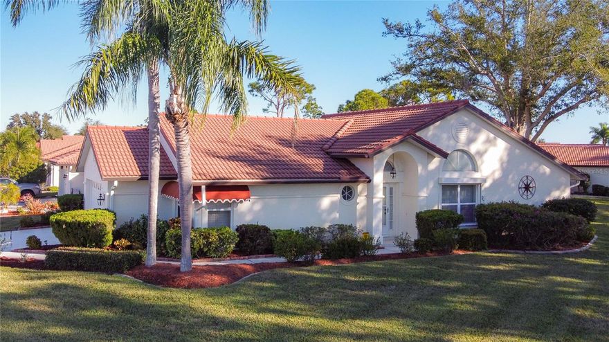 This is it! Move right in and enjoy the winter in Florida. Furnished and ready for you! This lovely cared for home is perfectly located on a corner lot. Open floorplan features a combination Living room/Dining room with cathedral ceiling. Sliding doors walk out to the Super large lanai with electric hurricane shutters for privacy and protection. The master bedroom features a large walk-in closet and ensuite bath with separate shower and tub. Lovely eat-in kitchen features pantry for storage and a greenhouse window. This home has been lovingly cared for  and would be a great place to call home. List of improvements are available.