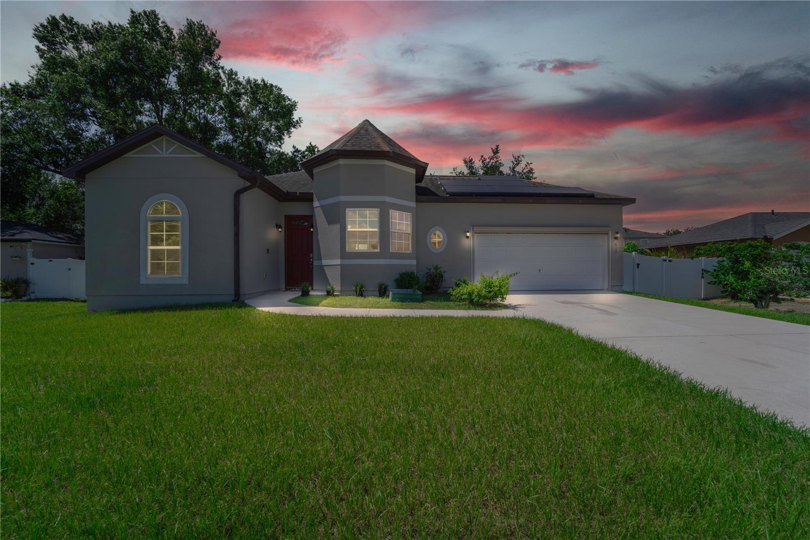 With its castle-style front tower, 612 Parakeet Ct in Poinciana is ready for new owners. Built in 2018, this 3-bedroom, 2-bath home offers 1,406 sq. ft. of bright, open living space that’s perfect for everyday life or hosting friends. The kitchen has plenty of cabinets and opens to the living and dining areas, making it easy to cook and entertain. The home is fully fenced for privacy and includes leased solar panels that the buyer can easily take over, helping you save big on electricity, especially during Florida’s hot summer months when bills run high. The low monthly HOA fee even covers cable and Wi-Fi, making this an amazing deal. Outside, the large yard gives you room to garden, play, or relax. Located in a quiet neighborhood, this home offers style, comfort, and savings all in one.