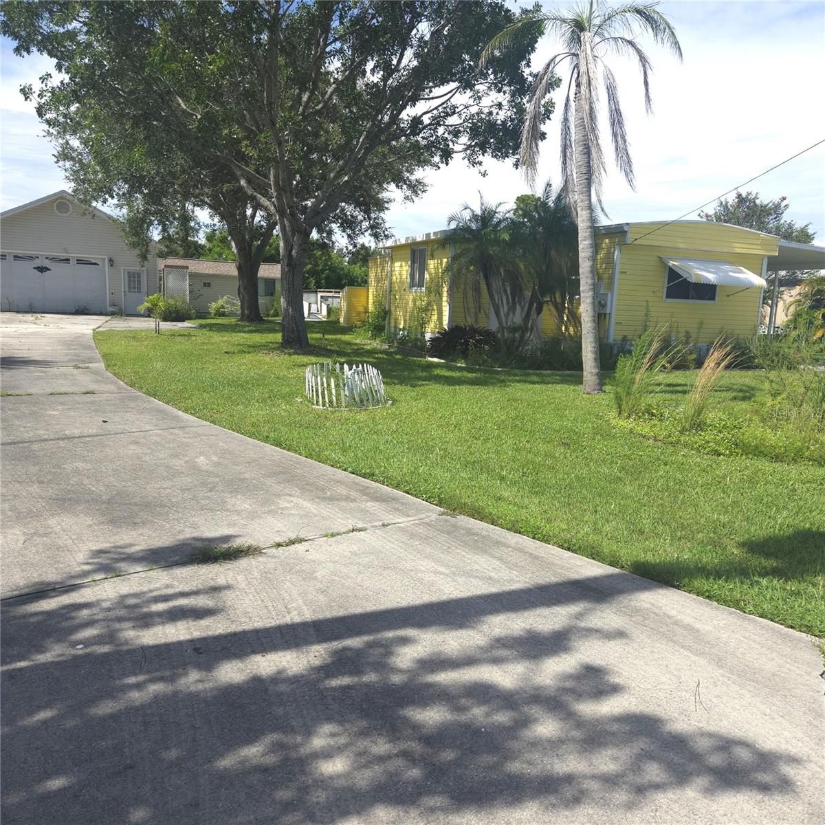 You will be surprised how nice this is inside! This property is a GREAT deal, with so many possibilities. This unique property has the main house (Double-wide mobile home) is very spacious, a detached, over-sized, 2 car garage, that has a bath, washer/dryer and kitchen sink. Also, a small, attached apartment/in-law, and an inground POOL!! Nice community without restrictions, no HOA and no lot fee. Bring your RV, bring your Boat! Close to Punta Gorda airport, hotels, restaurants, and Fishermans village, several parks and of course the Harbor. Needs some TLC, but the seller has addressed the roof, flooring, skirting and new grab bars on exterior. Sold As is, with right to inspect. A lot of property for the price. Affordable living. Close to Blue Heron Pines Golf Course.