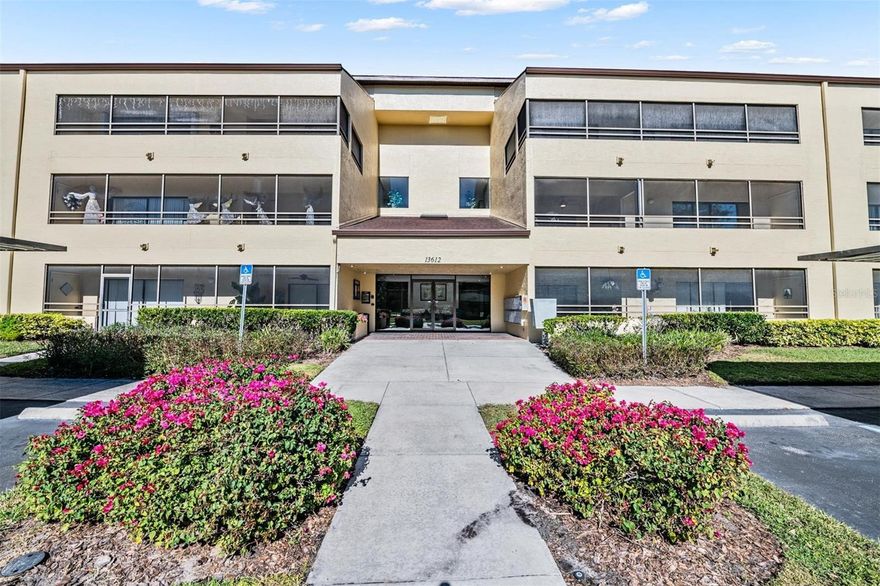Do not miss the opportunity to make an appointment to see this highly desirable 3/2 spacious corner unit in Village Towers, located in the heart of Carrollwood. Rarely does a 3-bedroom unit become available. Upon entering the building through the secured key entry lobby, you will find a lovely sitting area. Take the elevator to the second floor and you are home. This unit offers views from every room, with sliding doors leading to the expansive wrap-around balcony, perfect for enjoying coffee or drinks year-round. Additionally, there is a storage room on the balcony. The split plan design provides privacy for the primary bedroom, which features an ensuite bathroom with a large granite vanity and walk in closet. There are two additional bedrooms situated on the opposite side of the condominium, accompanied by a second bathroom. The kitchen includes a pass-through bar open to the living room, coffered ceiling, tile floors, granite counters and abundant cabinetry, with all appliances provided. The convenient indoor laundry area includes shelving and comes equipped with a washer and dryer. The current owner has installed heavy duty-hurricane resistant sliders on all doors as well as hurricane shutters. The covered, reserved parking space is conveniently located just outside the building's entrance, with ample guest parking also available. Village Towers is situated near the new Carrollwood Village Park, which offers a playground, splash pad, dog park and walking trails, minutes to fine dining and shopping, Carrollwood Golf and Country Club and VISTA community garden. Enjoy the nearby Carrollwood Cultural Center, featuring various classes, concerts, shows, and festivals. The upscale neighborhood of Carrollwood boasts beautiful tree-lined streets with sidewalks, ideal for morning or afternoon walks. This location also provides easy access to I-275, Veterans Expressway, hospitals, and Tampa International Airport. Schedule your showing today to secure this desirable residence.