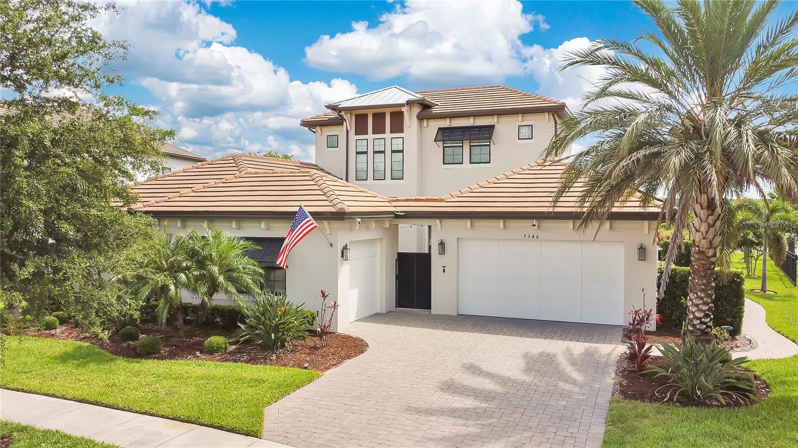 This home truly has it all. Nestled in The Overlook at Hamlin—one of the most vibrant and sought-after lakefront communities—this custom Taylor Morrison residence combines luxury, energy efficiency, and everyday convenience. Ideally located just minutes from Disney with easy access to Hwy 429, the home offers both lifestyle and location.
Set on the scenic shores of Lake Hancock, the thoughtfully designed floor plan features all main living spaces on the first floor, plus an upstairs media room or optional fifth bedroom with private bath. The primary suite is a tranquil retreat with stunning lake views and a spa-inspired bath.
High ceilings with crown molding and wood beams, abundant natural light, and a stacked stone fireplace create a warm, inviting atmosphere. Gorgeous tile floors flow throughout. The chef’s kitchen impresses with a natural gas cooktop, quartz island, French door oven, and walk-in butler’s pantry.
Step outside to your private lakefront oasis—a screened lanai with resort-style saltwater pool and spa, sun shelf with umbrellas, and a summer kitchen perfect for entertaining. Just beyond, a floating dock offers direct lake access.
Enjoy low utility costs thanks to a fully paid-off whole-house solar system and a tankless gas water heater—average electric bills are just $78/month.
Additional features include a gated front courtyard for added privacy and security, and access to Overlook’s resort-style amenities, including a fitness center, community pool and splash pad, parks, and a private boat ramp for residents. Furnishings may be available.