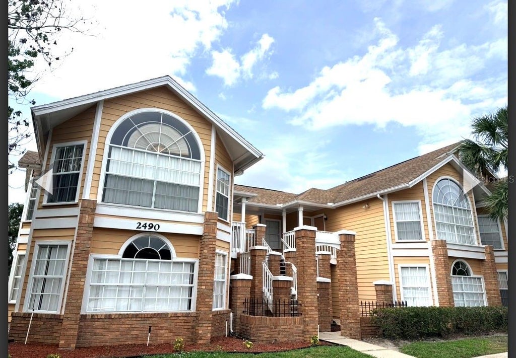 Photo of 2490 Sweetwater Club Circle #65, Kissimmee, FL 34746 (MLS # S5159065)