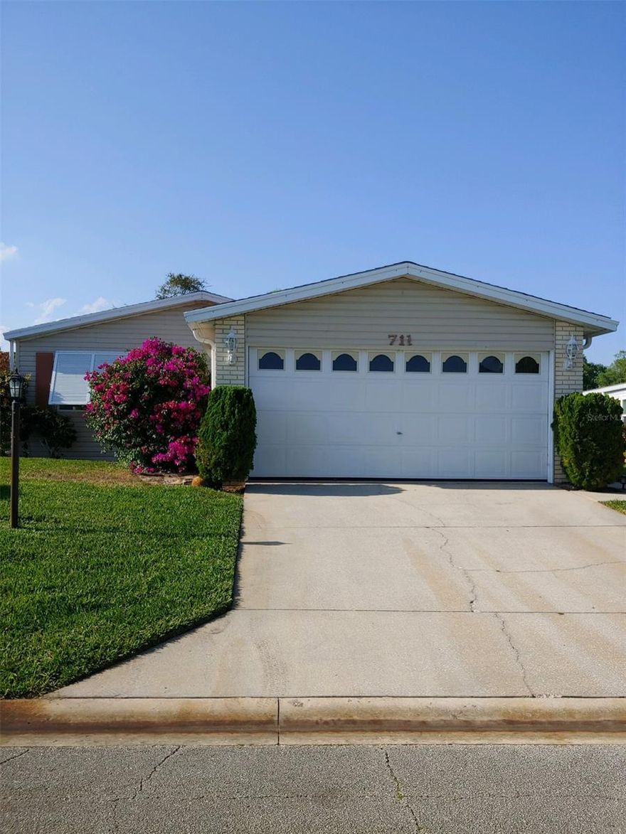 Enjoy living in Edgewater Landing, the 55 plus community on the Intercoastal Waterway where you own the land and have no lot rent.  This spacious 1994 Palm Harbor Triple wide  3 bedroom split plan home hosts an open floor plan with large living room and a family room that has a fireplace and built in bookcase,   formal dining room with built in china cabinet,  large eat-in kitchen with cork flooring and stainless appliances. Enjoy the private screened-in  lanai. Home has 2 stall garage and is located on a cul-de-sac. Home comes partially furnished and has custom window treatments.  Recent upgrades include:  New roof 2014, hot water heater 2017, Manufactured Hardwood floors through out 2017, Interior painting 2017, Daikin Air/Heat Conditioner Unit 2018 with transferable 12 year warranty, Lawn irrigation pump 2019, Hurricane Shutters 2020.   The landing has a clubhouse with  community heated pool, hot tub, tennis and pickleball courts, shuffleboard and bocce courts, walkway along the mile of frontage on the Intercoastal Waterway, wood-working shop, and exercise room. There is a lighted fishing dock and also a boat launch and dock with a seating area where you can sit back and watch the dolphins swim by.  There are storage areas for boats and RV's when space is available. ;Water: City