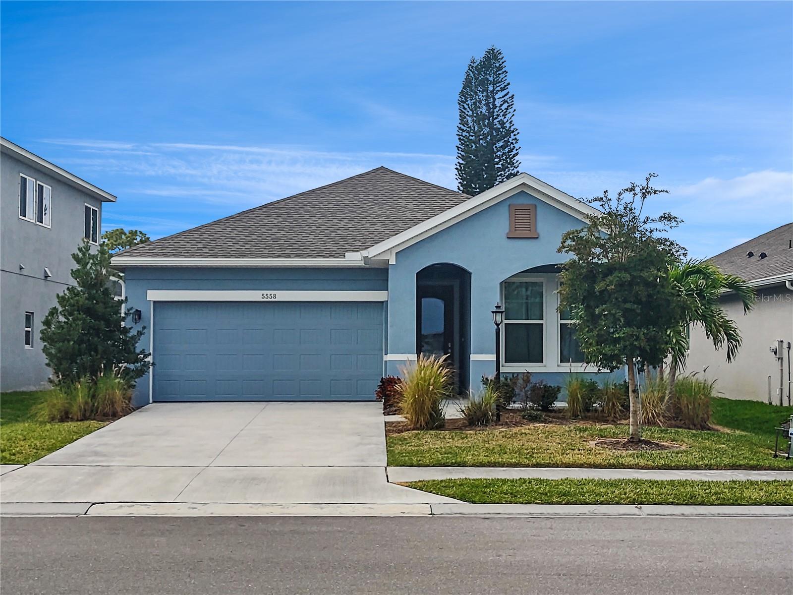 Price Reduced! Seller Motivated! No CDD fee and Low HOA. Welcome home to the private gated community of Moss Creek. This bright, well-constructed block David Weekley Home was built in 2019 boasting modern amenities to provide you with care-free living. Light abounds with oversized windows in this spacious split plan 3 bedroom 2 full bathroom home conveniently located on a cul-de-sac. The combined kitchen, dining and great room create a spacious and seamless flow. Quartz countertops and Whirlpool stainless-steel appliances grace the kitchen along with ample tall cabinets and an island that allows for seating and even more counter space. The primary bedroom has a walk-in closet and an en suite bathroom complete with a large double sink vanity, oversized mirror, zero-clearance walk in shower and neutral tile. The two additional bedrooms are well-sized and easily access the second full bathroom complete with a shower and tub combination also done in a tasteful tile. The two-car garage with direct entry to the home’s interior offers convenience on those rainy days as does the separate interior laundry room with shelving. There is a covered patio to welcome you and your guests at the home's entry and second covered patio at the rear of the property to relax and entertain. The home is equipped with hurricane shutters with the exception of the garage, it has an in-wall pest system and central air-conditioning. Best of all you can relax at the clubhouse and lovely community pool. Your next chapter begins here. There is a month to month lease currently in place, please contact the listing agent for details. Do not wait and set up a showing today! Property Sold As-Is.
