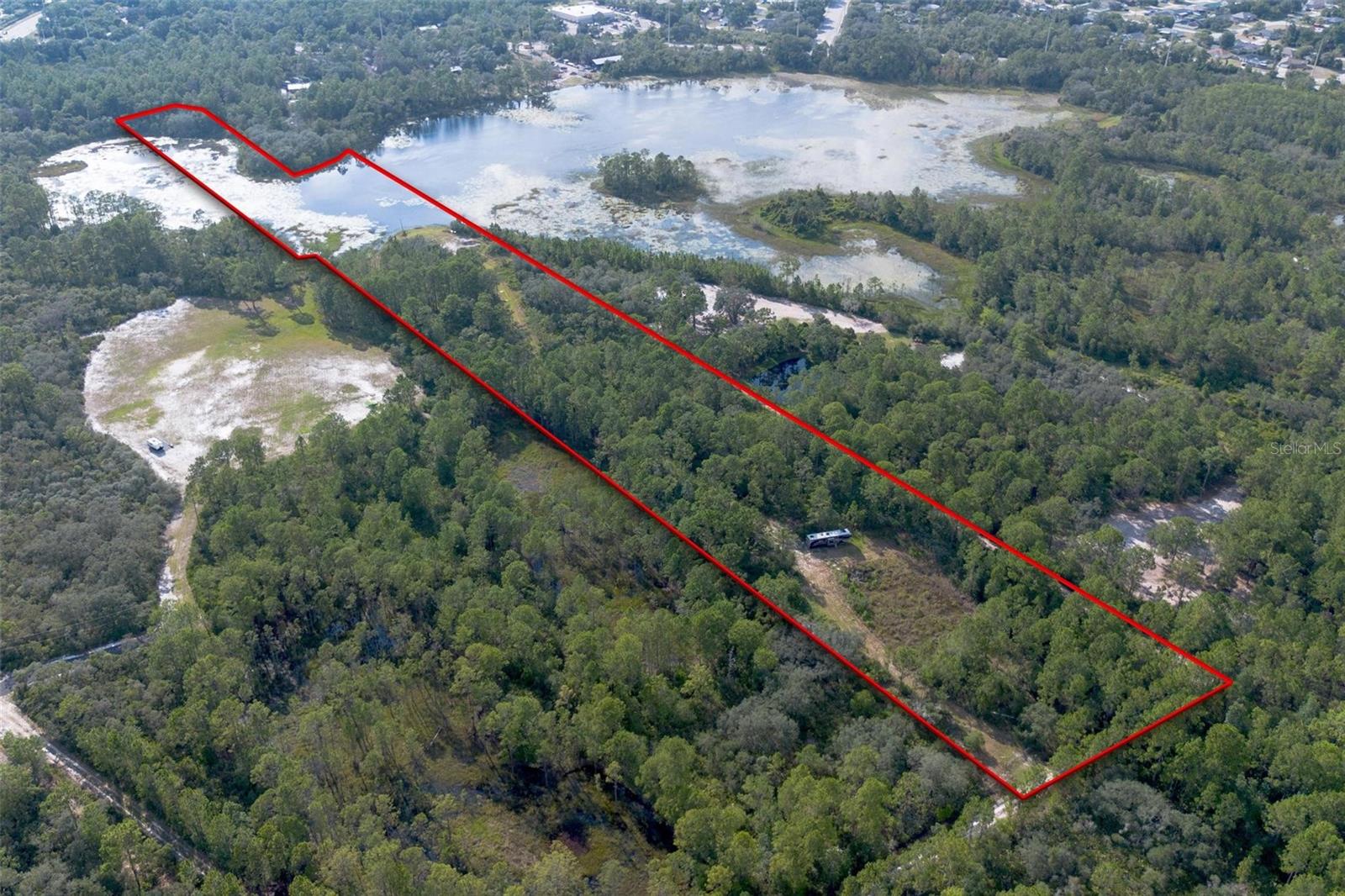 Welcome to your dream homesite! This stunning 14-acre parcel of vacant land offers the perfect blend of privacy, natural beauty, and convenience. Tucked away between Sanford and New Smyrna Beach, this expansive property features private lake frontage on a serene, fish-filled lake – ideal for peaceful mornings on the water or casting a line for your next big catch.
The homesite has already been cleared and perfectly positioned to maximize the gorgeous lake views, making it ready for your custom-built dream home or weekend retreat. Whether you're envisioning a cozy cabin, a modern farmhouse, or a luxury estate, this land provides a blank canvas in an idyllic setting.
Enjoy the tranquility of country living with the bonus of being just a short drive from shopping, dining, and major roadways. You’ll feel worlds away while still being conveniently located to all the essentials.