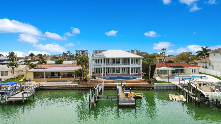 Nestled within the highly sought-after Yacht Club Estates boating community, this Key West style residence epitomizes the allure of waterfront living. Boasting 5 bedrooms and 4.5 bathrooms, this estate stands as a testament to the luxurious Florida lifestyle, while offering a vast array of impressive features and amenities throughout. This style of architecture exudes the utmost charm, while the lush landscaping sets the stage for what lies within.As you step inside, prepare to be captivated by the grandeur of an expansive great room. Here, the sweeping water vistas greet you through the spectacular wall of windows, inviting the beauty of the waterfront indoors. With soaring 22-foot ceilings, experience an air of spaciousness bathed in natural light. Immediately adjacent to the great room lies the heart of this home…the gourmet kitchen. Meticulously designed to cater to the most discerning chef, the kitchen boasts gleaming countertops, custom cabinetry, and high-end appliances, while a generous pantry ensures ample storage for all of your culinary delights. After dinner, head upstairs to the loft and game area which offers scenic views of the intracoastal waterway. Each of the 5 bedrooms is designed to provide a haven of tranquility, with the master suite standing out as a true sanctuary. Complete with a lavish bathroom and access to a spacious covered deck, it offers panoramic views of Tampa Bay, inviting you to unwind in absolute serenity. Outside, the impeccably landscaped grounds beckon you to enjoy the outdoors in style. A PebbleTec saltwater pool and spa offer a refreshing escape from the Florida sun, while a tranquil fountain adds a touch of elegance to the surroundings. Host “talk-of-the-town summer pool parties on the custom deck, or lounge peacefully at sunset while overlooking the picturesque waterfront. With direct access to the Gulf, this home epitomizes the ultimate waterfront lifestyle. Whether you're enjoying a leisurely boat ride, sunbathing by the pool, or simply taking in the breathtaking views, every moment spent here is an experience to cherish. It’s the perfect retreat for those seeking the pinnacle of waterfront living.