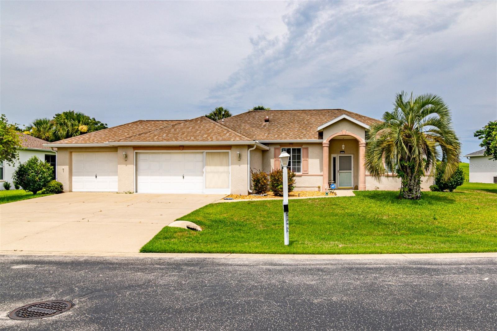 Adult 55+ Community, this is one of the few homes in the Ocala Palms Golf & Country Club that has a full 3 car garage, including a built-in generator with its own built-in electric connection on the wall, a Workshop, (including an Electric grinder) built in air pressure hose, Water softener system, sprinkler system and plenty of cabinets for storage. This 3 bedroom 2-bathroom home includes a complete security system with remote control, glass breakage, and motion sensor. Immediately notice high ceilings throughout, a large living room, with a beautiful brick gas fireplace for those chilly nights, a formal dining room, as well as an eat-in kitchen with a bay window overlooking the golf course. The split floor plan gives you that extra privacy in your master suite. The third bedroom includes a murphy bed which folds into the wall. Therefore this 3rd room can also be used as an office! Located near the 15th hole on a .26-acre oversized lot, backing up to a raised green area on the Golf Course making your backyard view extremely private! Enjoy watching the sunset from one of the two lanais. One is enclosed with new windows installed March 22, 2023; couch will be staying. The adjacent lanai is screened in and includes a grill, making it perfect for entertaining and grilling. Upgrades include a New A/C in 2020, Laminate Flooring & Roof Replacement in 2014. The Community Amenities include the following: an indoor heated pool, outdoor pool, hot tub, pool tables, Library, tennis courts, pickleball, exercise room & periodic functions including concerts to name a few. Freezer in the garage will be removed by the seller. This property is for lease or sale, whichever happens first.