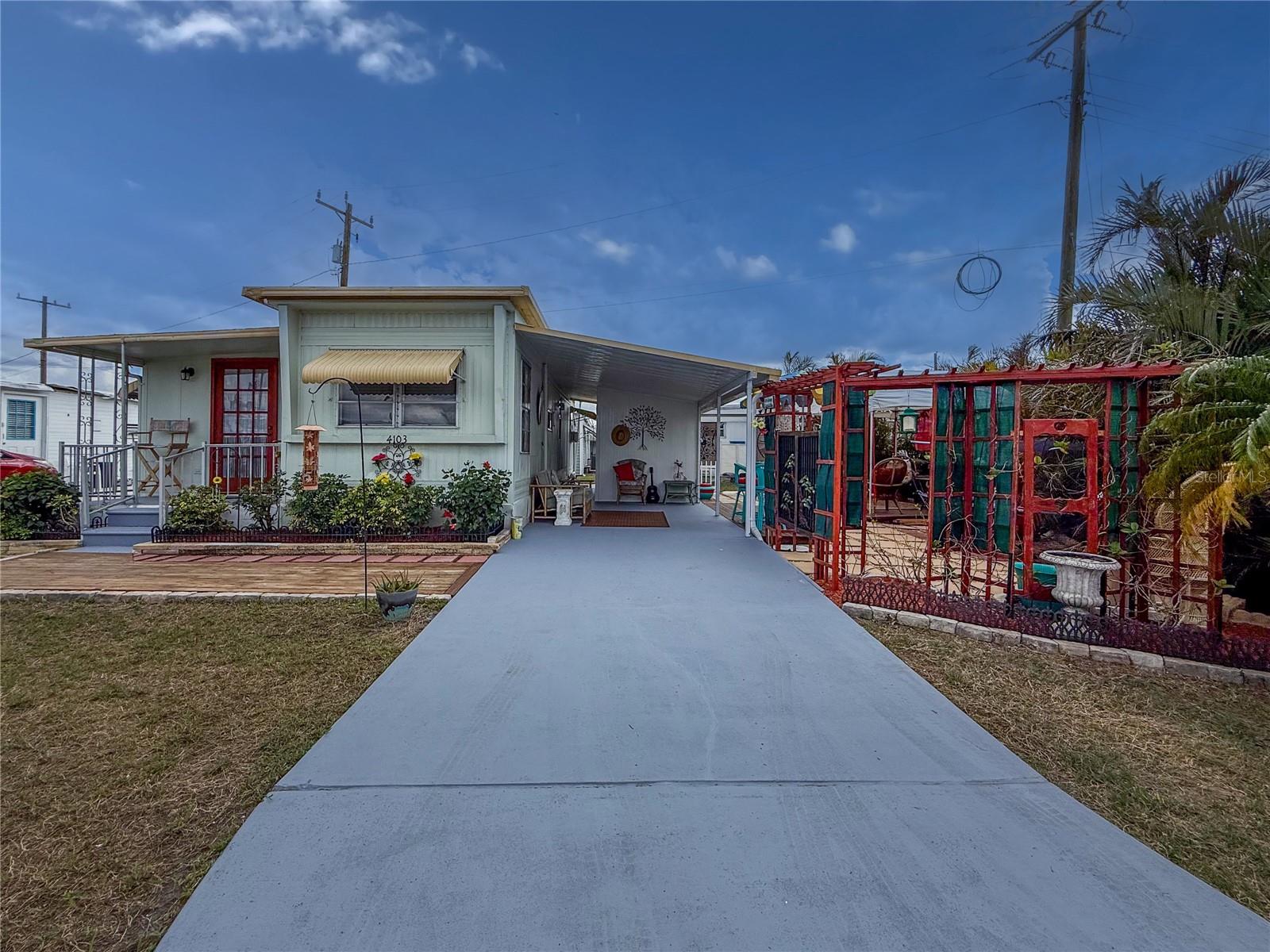 Welcome to your dream retreat in the sought-after 55+ community of Tidevue Estates! This charming land-owned mobile home offers the perfect blend of privacy and community spirit. Step inside and be greeted by a bright and light space setting a cheerful tone throughout. With two cozy bedrooms and one bathroom, and a well-appointed eat-in kitchen with solid wood cabintes and extra prep space with the kitchen island. Live out your golden years with ease. This home is more than turn-key; it’s a turnkey to your new life, fully furnished for an effortless move. Just pack a suitcase, and get ready to start your life of leisure in Tidevue Estates. Outside, the property truly shines with a fantastic outdoor living area. This boasts a deck that offers privacy and a picturesque setting amid lush landscaping for those who appreciate a bit of greenery and privacy — ideal for sipping your morning coffee or hosting lively gatherings with friends. Additionally, a covered carport with an attached shed provides a practical space for hobbies and laundry. Come join the Tidevue lifestyle and find out why your neighbors never want to leave! Community amenities? We've got them in spades! From a solar heated swimming pool to dive into a water aerobics class or to cool off on those hot Florida days, a fitness center for staying in shape, to social clubs, bocce ball, pickleball, shuffleboard, there’s no end to the fun and camaraderie here. Just a hop and a skip from major highways, the Ellenton Outlet Mall, restaurants, shopping centers, the majestic Manatee River, and a short drive to our beautiful gulf beaches the convenience is your new best friend.