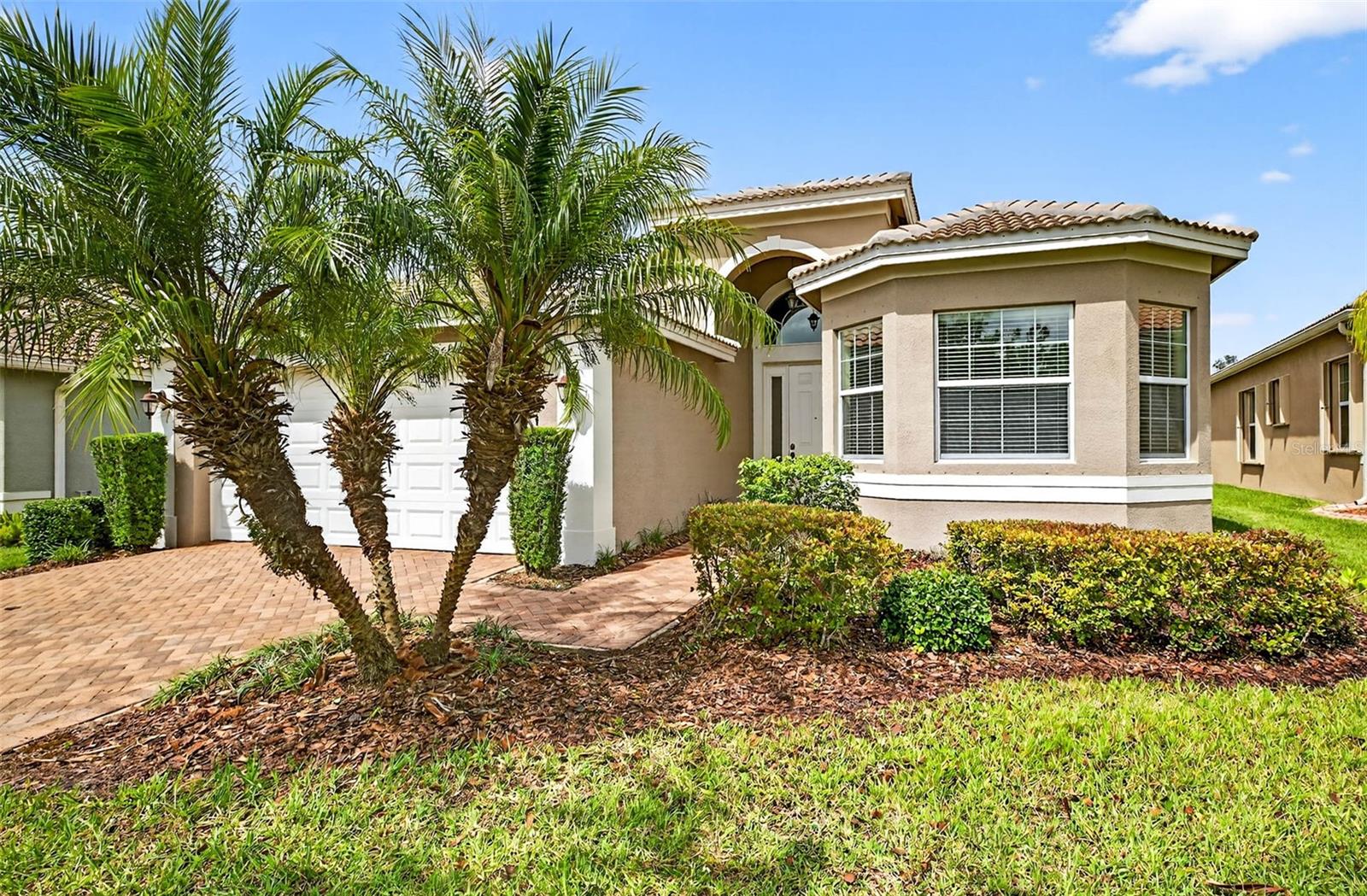 Beautiful Florence model with stunning water views now available! Enjoy privacy and wildlife right from your own backyard. Step into the foyer and take in the expansive view through the large sliding glass doors. The entire home has been freshly painted and features neutral tile flooring throughout for a clean, cohesive look.
The kitchen is well-appointed with wood cabinetry, granite countertops, cabinet lighting (above and below), and glass door accents. A spacious breakfast bar and casual dining area make it ideal for everyday living and morning coffee. The open floor plan flows seamlessly from the kitchen to the dining room and great room, creating a perfect space for entertaining.
A versatile den with double doors and tile flooring can serve as an office, guest room, or additional living space. The large second bedroom is conveniently located near the second full bath, which features wood cabinetry and a tiled tub/shower combination.
The primary suite overlooks the water and includes two large closets and a luxurious en-suite bath with a massive tiled shower, dual sinks, and ample wood cabinetry. Additional features include ceiling fans, lighting fixtures, and a washer and dryer.
All of this is located in Valencia Lakes, Florida’s premier 55+ community where every day feels like a vacation. Enjoy the resort-style clubhouse, swimming, fitness center, tennis, pickleball, and a variety of social activities. Experience the Florida lifestyle in your own piece of paradise—come see why you'll love calling it home!