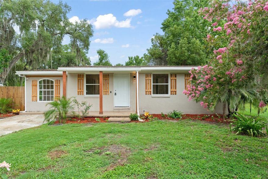 **This house comes with a REDUCED RATE through the seller's preferred lender. This is a lender-paid rate buydown that reduces the buyer's interest rate and monthly payment.**Welcome to 247 Toms Rd – A Cozy Retreat in the Heart of DeBary. Tucked away on a peaceful, 0.30-acre lot with no HOA, this charming 3-bedroom, 2-bathroom home is full of warmth, character, and quiet comfort. As you drive up the paved driveway, you're greeted by the home's welcoming presence—wood-toned pillars on the covered entry and matching faux wood shutters, all surrounded by subtle, thoughtfully maintained landscaping that sets a peaceful tone. Step inside and you'll find a galley-style living and kitchen area, enhanced by a vaulted ceiling and durable laminate flooring throughout. The layout is cozy yet open, with a kitchen pass-through window connecting the spaces and inviting conversation. The kitchen itself is light and bright, featuring white cabinetry, stone countertops, stainless steel appliances, and a sliding glass door that opens up to views of the private, grassy backyard. Just off the kitchen, you'll find a unique bonus—an in-law suite, complete with its own ensuite bathroom, built-in closet, and private exterior access to the side yard. It’s perfect for guests, extended family, or even a private workspace. The home’s split-bedroom layout provides privacy for the primary suite, located on the opposite side. This tranquil retreat features a large built-in closet and an ensuite bath with floor-to-ceiling tiled shower and crisp white vanity. The third bedroom, also with a built-in closet, is served by a stylish third bathroom just outside the door, complete with a tub/shower combo, vessel sink, and stone countertops that echo the kitchen’s elegant finishes. Step out back to discover a paved patio area and an inviting grassy backyard framed by mature trees and natural vegetation that offer both beauty and privacy. It’s a blank canvas waiting for your personal touch—whether it’s a garden, a firepit, or space for pets and play. 247 Toms Rd is more than just a house—it’s a place where memories are made, and life feels just a little bit quieter, warmer, and more connected.