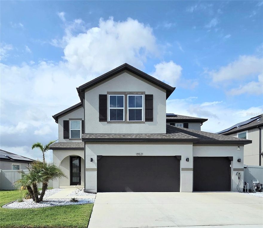 Welcome to resort-style living in the highly desirable Reserve at Pradera community! This beautifully maintained 5-bedroom, 3-bathroom Beazer Captiva model offers nearly 3,000 heated square feet and over 3,700 total square feet of thoughtfully designed living space. Only 3 years old, this home offers peace of mind with like-new major components including the roof, HVAC, plumbing, electrical, and water heater. Inside, you’ll find upgraded accent walls and a gourmet-style kitchen featuring quartz countertops, built-in features, abundant cabinetry, and an open layout perfect for entertaining. The oversized 638-square-foot 3-car garage is a standout feature, complete with a separate third-car stall equipped with its own mini-split A/C, epoxy floors, five heavy-duty ceiling storage racks rated for over 600 pounds each, and an included electric vehicle charging station. Step outside to enjoy the fully fenced backyard overlooking a peaceful pond, screened and covered lanai, and dedicated dog run — perfect for relaxing or entertaining. One thing we can't forget to mention is the solar panels, and with an acceptable offer they will be paid off at closing. This incredible community with an HOA under $200 yearly, allows residents to enjoy a resort-style pool, splash pad, dog park, basketball courts, scenic trails, and sidewalks throughout the neighborhood This move-in-ready home combines modern upgrades, functional space, and exceptional community living all in one.