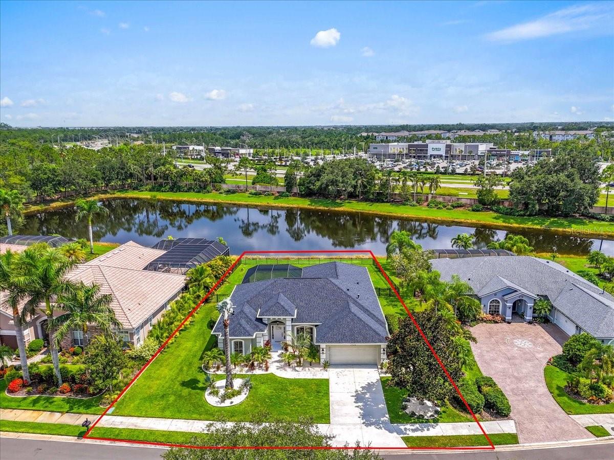 Modern retreat with stunning Water View and Nature Preserve views fully fenced backyard on an oversized private lot, 1438 Brambling CT, Bradenton, FL 34212. 4 spacious bedrooms, 3 bathrooms, heated pool, nestled in the highly sought-after, multigenerational gated community of Greyhawk Landing. The home offers the perfect blend of privacy, serenity, and upscale Florida living with flexible living areas, ideal for multigenerational living, remote work, or visiting guests. From the moment you arrive, you'll be captivated by the lush tropical landscaping and pristine curb appeal. Inside, high ceilings, new luxury laminate flooring, modern finishes and thoughtful upgrades abound, from sleek fixtures, modern lighting all on dimmer switches to fresh, contemporary design touches that create a warm and stylish living space. The primary bedroom is on one side of the home for added privacy, with sliders overlooking the heated pool, and water views, large walk-in closet, ensuite bathroom with dual vanities, garden tub and separate shower. The heart of the home features an open-concept kitchen, oversized quartz countertops for added storage, island with breakfast bar, newer appliances, soft close drawers, built in wine fridge, gas range, and living area, perfect for entertaining or enjoying quiet moments, dining. Step outside to your private, screened lanai with outdoor space for added kitchen and take in the panoramic views while relaxing in the heated pool, your own peaceful oasis with no rear neighbors in sight on a quiet cul-de-sac street. *** Features: NEWER ROOF, NEWER AC, HOT WATER HEATER, POOL HEATER and EQUIPMENT, FENCED BACKYARD, GARAGE FLOOR EPOXY, WELL FOR IRRIGATION. Greyhawk Landing is known for its resort-style amenities, scenic nature trails, and vibrant community atmosphere, low HOA $75 A YEAR, with access to a full club house, fitness center, tennis courts, pickleball courts, soccer/baseball fields, 2 community pools, that includes one lagoon style with water slide and waterfall, spa, basketball courts, playgrounds, miles of nature trails for biking and walking, fishing pier located on a large lake stocked with fish for occasional fishing. Top rated schools and colleges, LECOM, conveniently located close to Lakewood Ranch, Sarasota, St-Pete, Tampa, Restaurants, shopping, Airports, UTC, and world renown Beaches, boating and golf courses. Live in harmony with nature and see why this is an exceptional home that is truly move-in ready and offers the lifestyle you’ve been dreaming of in Greyhawk Landing. Call for your private showing today!