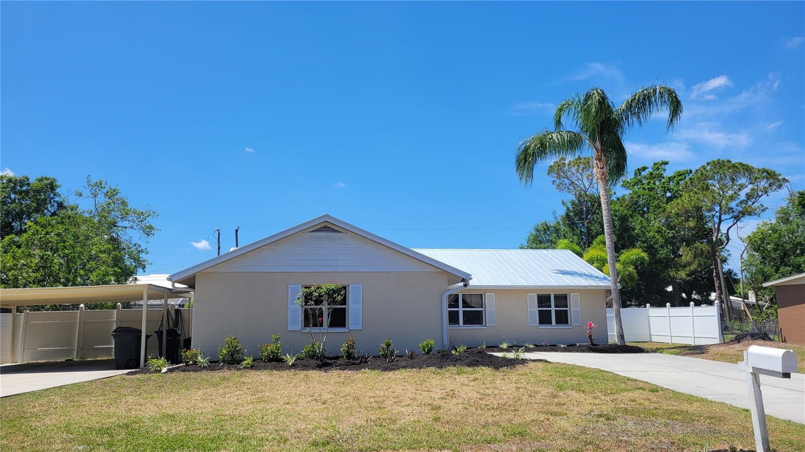 This spacious and bright annual unfurnished 3-bedroom, 2-bathroom home is ready to be your next residence. Enjoy generously sized bedrooms filled with plenty of natural light streaming through large windows and a sliding glass door that leads to a large Florida room—a versatile, un-airconditioned bonus space perfect for a playroom, hobby area, or casual lounge. The home features solid surface flooring throughout, with tile and laminate—NO carpeting, making it both stylish and easy to maintain. A recently installed roof adds peace of mind, and the large fenced-in yard offers ample outdoor space for pets, entertaining, or gardening. Parking is a breeze with a one-car garage plus an oversized carport. Located in a convenient area close to shopping and just minutes from Siesta Key, this home offers a blend of comfort, functionality, and an ideal location. Call now to schedule your tour—your next home is waiting!
