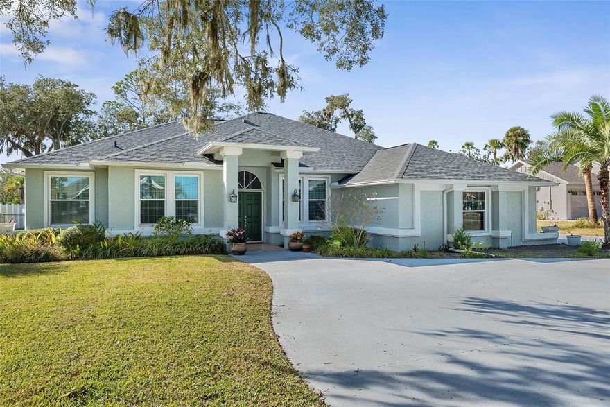 LOWEST PRICE  home on PRESTIGIOUS Lambert Avenue. Desirable 4 bedroom, 2 bath traditional home with a circular driveway situated on over AN ACRE of beautiful land with no backyard neighbors. There is plenty of room to add a pool while still enjoying exceptional privacy.  Boasting over 2,300 sq. ft. of living space under heat and air, plus a large screened patio, this split bedroom floor plan features high ceilings, a formal living room and dining room, and a spacious family room ideal for gatherings. The eat-in kitchen offers granite countertops, backyard views perfect for enjoying local wildlife, and ample space for entertaining.  Additional highlights include a 2-car garage with side entry, newer roof 2023, fenced yard, and almost all newer hurricane-rated windows 2018 excluding the sliding door and interior exterior paint 2018. Front gutters installed 2017. Located across from the Intracoastal Waterway with slight views of the ICW from your front yard and surrounded by million-dollar homes, this property offers a rare combination of space, setting, and value. A bonus rain barrel adds a thoughtful touch for the gardener in the family and the gator mail box conveys. GO GATORS! ALL THIS AND ONLY 5 MINS TO THE BEACH! Book your tour TODAY!