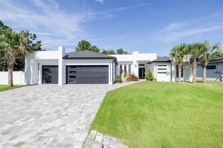 Under contract-accepting backup offers. WHY WAIT TO BUILD WHEN EVERYTHING IS ALREADY DONE FOR YOU-THIS STUNNING MOVE -IN READY CONTEMPORARY 3- BEDROOM, 2-BATH HOME FEATURES 109 UPGRADES AND DELIVERS A COMPLITELY TURNKEY EXPERIENCE WITH ZERO STRESS AND ZERO ADDITIONAL COSTS. A dramatic 16-foot entry opens to an expansive living area with 12-foot ceilings, custom ceiling detail, and oversized energy-efficient windows that fill the home with natural light, while a 16-foot 4-panel sliding glass door blends indoor and outdoor living. The chef’s kitchen features an 11-foot quartz waterfall island with pop-up outlets and wireless charging, premium appliances, built-in oven and microwave, island cooktop, and walk-in pantry. The private primary suite offers direct pool access, a large walk-in closet, dual floating vanities with quartz countertops, an oversized walk-in shower, and a freestanding soaking tub, while the guest bath also opens to the pool for a true resort feel. Additional features include a laundry room with quartz counters and utility sink, an oversized insulated 2-car garage with epoxy flooring, 18-ft glass-paneled door, 8-ft windows, side entry, and EV-ready wiring, with the garage fully prepped for optional A/C. The home also includes energy-efficient systems tucked away in interior closets for added storage, a covered patio with outdoor summer kitchen and screened pool, a concrete turf driveway, exterior block walls, and 8-ft solid-core doors throughout. Ideally located just minutes from Flagler Beach, shopping, dining, parks, and schools, this home offers a perfect balance of luxury, function, and coastal Florida lifestyle. SCHEDULE YOUR PRIVATE SHOWING .