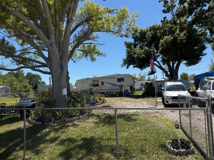 BRAND NEW FENCE!!! Zoned MHC for mobile home conventional. This lot already has the sewer and water hookups and electricity and a plug for an RV although RV parking is only supposed to be temporary. Till September 2027.They have a permit to park an RV there for the next almost 2 years. They're using it for gardening and will remove many of the plants that are potted and they have the fencing material to put up the rest of the fence on site. This lot has been cleared and well used and cared for. No HOA, deed restrictions or CDDs!!! Not in a zone requiring scrub jay mitigation per the county website 03/24/26 - please reconfirm during due diligence. Don't wait until demand exceeds supply!! This great Residential Single Family Home zoned lot in beautiful Port Charlotte is just waiting for you!! This is nearly a quarter of an acre of the sunny Florida dream. Although out in the scenic Florida landscape, this lot is still conveniently located to shopping, dining, banking, etc. New construction is everywhere you look and you can be part of the action. Information about builders available upon request. Also perfect for self-directed IRA's, 401K's and other investment portfolios. 13.1 MILES TO THE ENGLEWOOD BEACH!
