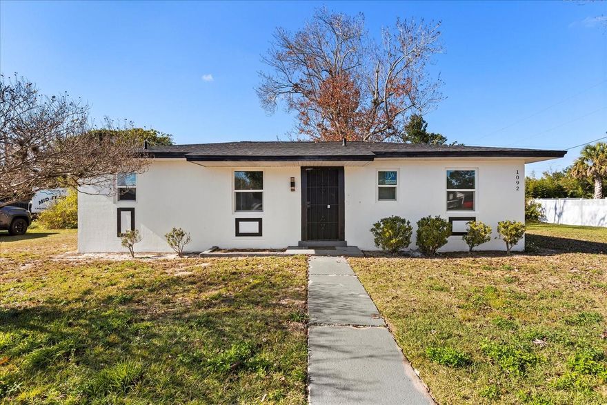1092 Deltona Blvd offers a fully renovated, move-in-ready home with a desirable 2 bedroom, 2 bathroom split floor plan and modern upgrades throughout. This home has been completely redone for peace of mind and everyday comfort, featuring a brand-new roof, new AC system, new water heater, and new windows! Inside, you’ll find new cabinetry, quartz countertops, and stainless steel appliances, creating a clean, contemporary kitchen that flows easily into the main living areas. The split layout provides added privacy, ideal for homeowners or guests.Situated on a spacious 10,000 sq ft lot, the property offers room to enjoy outdoor living, entertain, or expand. Relax year-round in the covered and screened porch/lanai, accessible through sliding glass doors—perfect for Florida living.With modern finishes, major system upgrades already completed, and a generous lot size, this home is an excellent option for buyers seeking a fully updated home with no deferred maintenance. Conveniently located near shopping, dining, and major roadways.