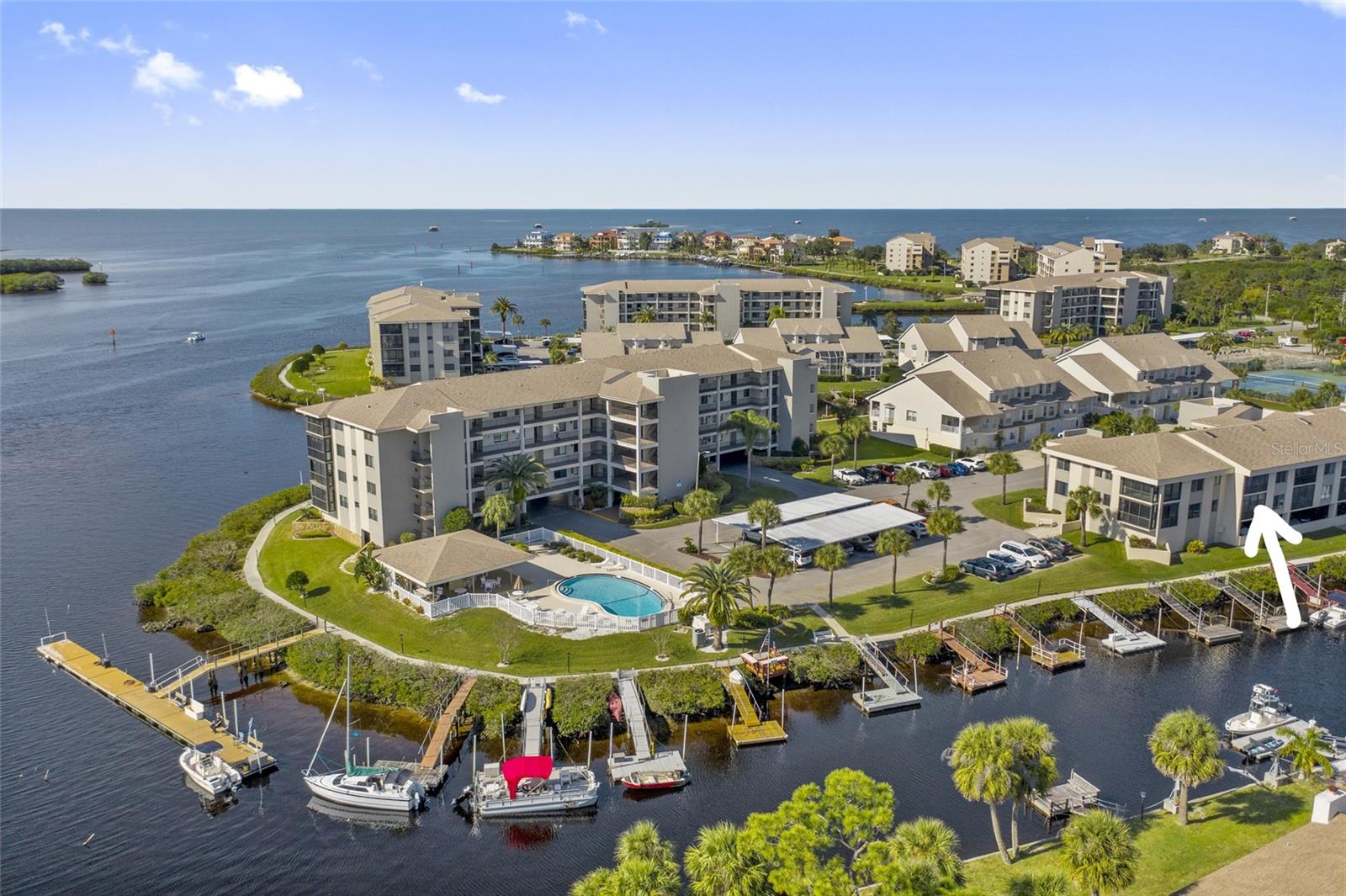 If you are looking for a CANAL FRONT condo, with easy access to the Gulf of Mexico, don't look any further. The new price includes private dock #14 along with the condo. Since docks are not deeded to the condo it will convey by bill of sale after closing.
Beautifully remodeled, CANAL FRONT condo in gated community available for purchase. Remodeled kitchen cabinets with granite counter tops, stainless appliances. Breakfast bar and eating space in kitchen. Dining room and living room combo with crown molding, sliding door access to patio offering direct view of the CANAL AND PARTIAL VIEW OF THE PITHLACHASCOTEE RIVER. Large master suite also offers water front view, large walk in closet and bath with new vanity, granite countertop and walk in shower. Luxury Vinyl Plank flooring throughout (new 2021), stainless refrigerator (new 2021)new plantation shutters in all windows, new chandelier in dining room, new ceiling fans in Master bedroom and lanai, new paint throughout, new mirror closet doors, new custom closet system, new lanai framing and screens (all new within the last year). Approx 3-4 yr ago previous Owner installed new Microwave, Range, Dishwasher, new cabinetry throughout, new granite counter tops, new toilets, new crown molding, new 5 1/2 " baseboards. It is believed that the Hot Water Heater 2017, AC 2008 (Buyer to verify). Seller also separately owns an RV site within the community (not deeded to condo). RV site #46 has a 30 ft long RV CARPORT and SHED. If you purchase the condo and have interest in the RV site please inquire about availability and price. Building has elevator. One assigned under building parking space and additional guest parking, assigned storage locker, two pools, cabanas with gas grills, tennis, putting green, boat ramp, waterfront board walk and fishing pier. Brand new clubhouse offers library, game tables, fitness room and card room. 24 hour security guard at gate. Close to waterfront dining, waterfront sports and activities, medical, shopping, Historic Down Town New Port Richey, approx. 20 min to the Tarpon Sponge Docks and Fred Howard Park, approx. 60 min to Tampa airport, approx. 60 min to famous Clearwater Beach, closer to multiple public beaches! **Not age restricted and no pets.