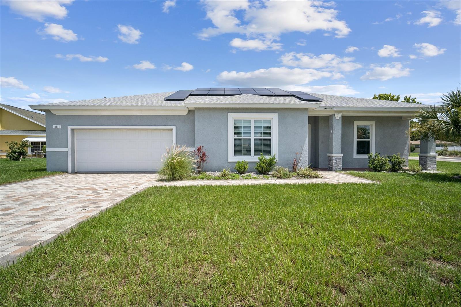 Welcome to your dream home in the charming Jasmine Lakes community! This stunning 4-bedroom, 2-bathroom single-story residence sits on a spacious 0.20-acre corner lot, offering 2,095 sq ft of beautifully appointed living space, ideal for families, entertaining, and Florida living. Key features include an open-concept design that seamlessly connects the living, dining, and kitchen areas, perfect for gatherings and everyday ease. Gourmet kitchen outfitted with stainless steel appliances, granite countertops, and stylish cabinetry. Master suite retreat featuring dual sinks, a separate soaking tub, and a walk-in shower. No HOA or CDD fees equals more savings and freedom. Energy efficiency boost with a solar system installed, reducing utility costs. Low-maintenance ceramic tile floors throughout provide a neutral palette ready for your personal touches. 2-car attached garage and driveway parking for convenience. Fenced-in yard & screened rear porch, ideal for entertaining or enjoying peaceful outdoor time. Additional highlights included, built in 2020 with sturdy block and stucco, a corner-lot location offering more space and charm. Community amenities: sidewalks, water views, no restrictive fees, and convenient access to US-19, linking you to shopping, dining, medical centers, entertainment, Jasmine Lakes Plaza, parks, and essential services within minutes.