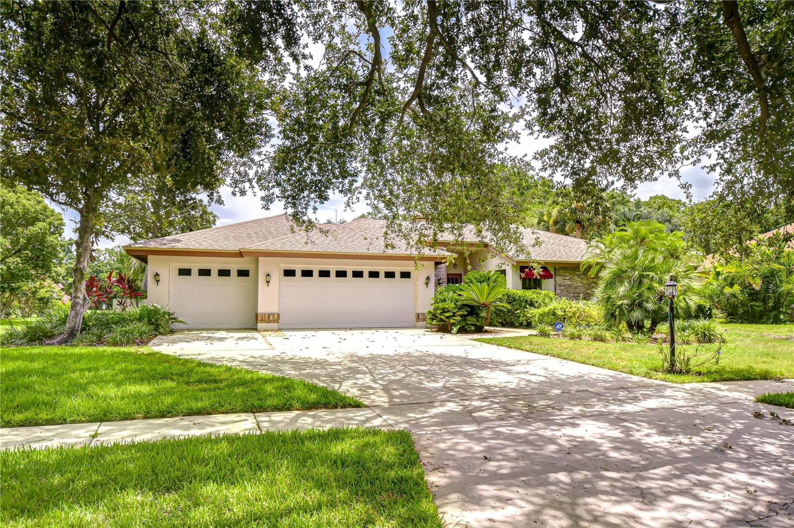 Don't miss this rare opportunity to own a home in the highly desirable community of Coventry at Tampa Palms. Nestled on a picturesque, tree-lined street, this residence sits on an extraordinary nearly half-acre lot—backing to a serene pond, the Tampa Palms Golf & Country Club, and lush conservation area. Enjoy the peaceful beauty of nature, complete with regular visits from deer and other wildlife. This distinctive 4-bedroom, 3.5-bath home offers 2,815 square feet of interior space and a spacious outdoor living area with a pool—creating the perfect canvas to bring your dream vision to life. Upon entering, you're welcomed by soaring ceilings and a bright, open layout. The formal living and dining rooms flow effortlessly, setting the stage for elegant entertaining. The kitchen overlooks both the family room and pool area and features ample counter space, a breakfast nook, and expansive views of the private backyard oasis. The primary suite boasts a vaulted ceiling, abundant natural light, a spa-style bathroom with dual vanities, tile countertops, a jacuzzi tub, step-in shower, and a generous walk-in closet. Secondary bedrooms are tucked away on the opposite side of the home for ultimate privacy. Step outside to the screened lanai and enjoy the tranquil scenery of the pond, golf course, and surrounding nature. Residents of Tampa Palms enjoy exclusive amenities, including a community pool, clubhouse, tennis, pickleball and basketball courts, two parks, and scenic walking trails. Ideally located near USF, Moffitt Cancer Center, the VA and AdventHealth hospitals, and just minutes to downtown Tampa. With easy access to major highways, you’re also within reach of Orlando, Sarasota, St. Petersburg, and Tampa International Airport. This is your chance to create something truly special in one of Tampa’s most coveted neighborhoods!