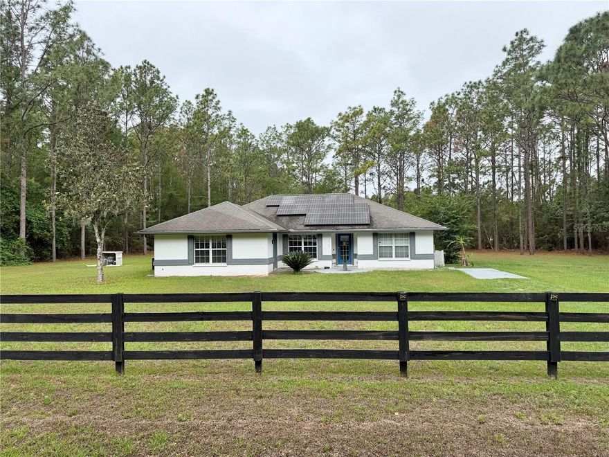 Enjoy the space and charm of this 3-bedroom, 2-bath concrete block home with a bonus room, built in 2003 on 2.5 acres in the Oak Ridge Crossing neighborhood. The kitchen boasts quartz countertops with a stylish waterfall accent, while the great room features beautiful "wood-look" tile flooring. The primary bedroom offers a walk-in closet, and its en-suite bath showcases updated tile & shampoo niche in the shower. The bonus room, with its own entrance, can double as a den or study. A screened porch with ceramic tile flooring overlooks the spacious yard, with ductwork ready for heating or cooling if enclosed. There’s also covered parking for a car, boat, or RV. Located in a quiet, home-only subdivision of just 32 homes, it’s minutes from Gainesville and I-75. Fiber optics & cable available. A solar panel feeding to Duke energy along with a well and septic utilities, add modern convenience and savings.
