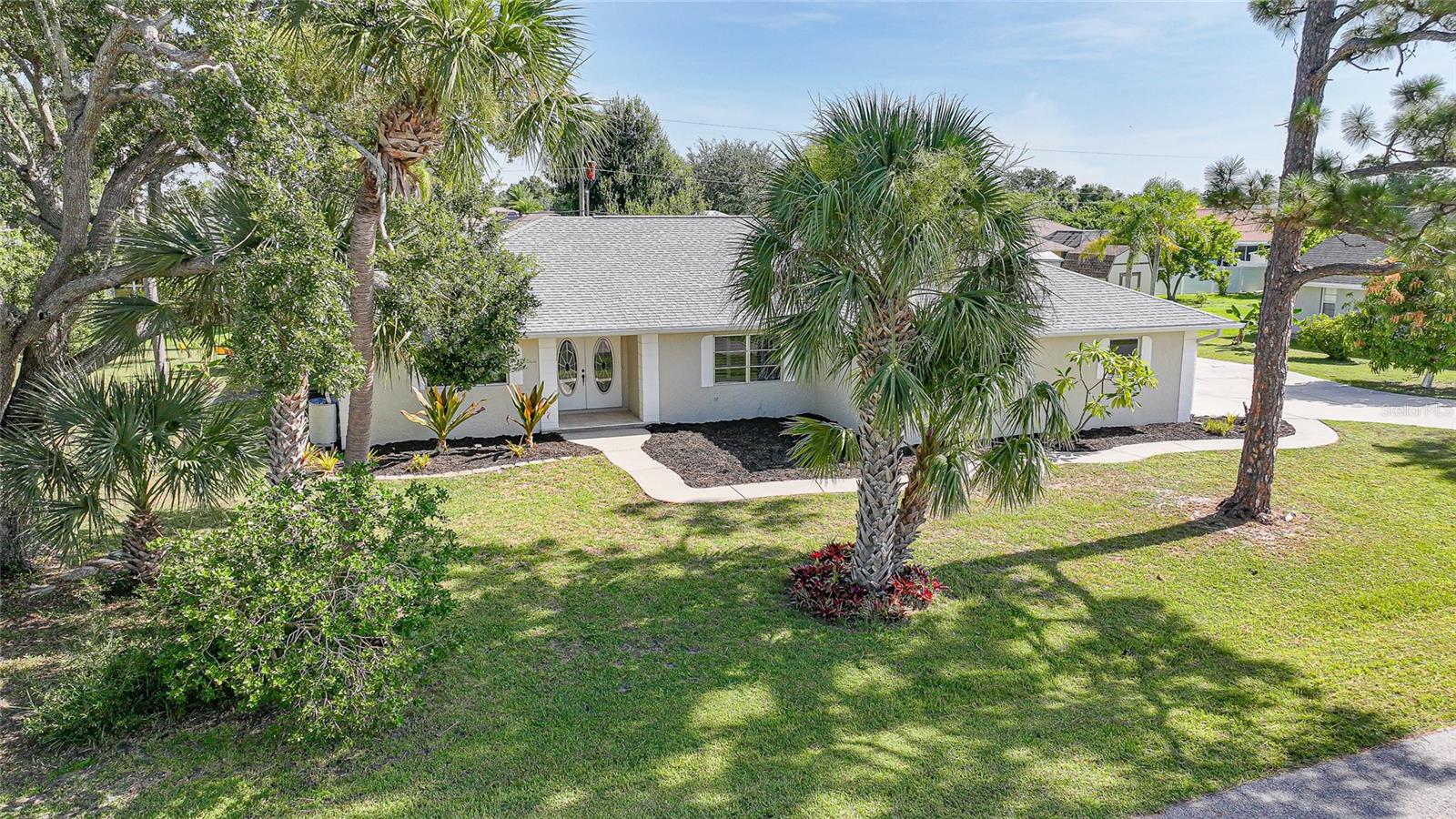 Centrally located in the desirable Section 15 of Port Charlotte, this spacious home sits on over half an acre and offers the perfect blend of comfort, functionality, and outdoor living. Featuring three bedrooms plus den, two bathrooms, and an oversized two car garage. The home is designed to accommodate a variety of lifestyles. The updated kitchen boasts an island with a breakfast bar with storage on both sides, solid surface countertops, stainless steel appliances, wall oven and a cozy dining area just off the kitchen. The inviting living room centers around a working fireplace, flanked by built-in storage cabinets, and flows seamlessly into the formal dining room both with views of the expansive pool deck. The oversized primary suite features tall ceilings, private access to the pool area, walk-in closet, and a beautifully updated en suite bathroom with granite countertops, wood cabinetry and walk in shower. Guest bedrooms are thoughtfully positioned, sharing a hallway and guest bathroom for added privacy. A third full bathroom, located off the kitchen and laundry area, conveniently doubles as a pool bath. Step outside to enjoy the Florida lifestyle on the large screened lanai, complete with a stunning pool and built-in spa, spacious deck area, and a fully equipped outdoor kitchen—perfect for entertaining. This home is ideally located near shopping, dining, and offers a short commute to some of Florida's finest beaches. Don't miss the opportunity to own this beautiful piece of paradise.