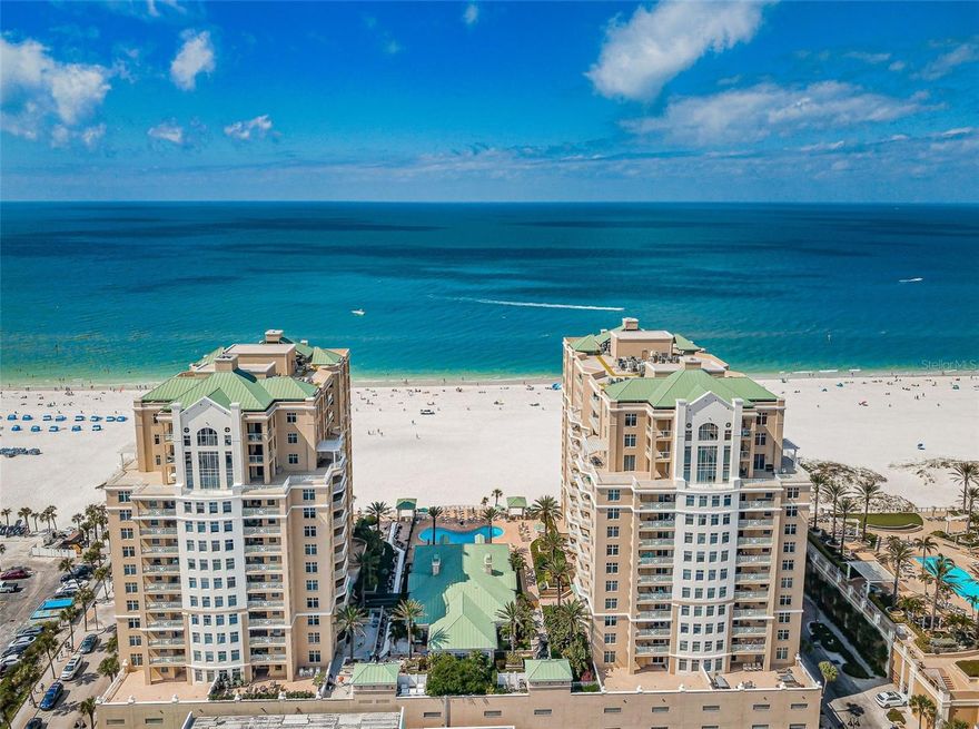 Welcome to the Mandalay Beach Club, the essence of luxury coastal living on sunny Clearwater Beach. Step into the pinnacle of opulence with this extraordinary 14th-floor penthouse offering unparalleled views of the sparkling Gulf of Mexico and the vibrant cityscape. Upon entering, dazzling views of the sparkling Gulf of Mexico awaits along with four spacious bedrooms, three full baths, two large terraces, 10 ft ceilings, modern finishes, floor-to-ceiling glass sliding doors, radiant expansive living areas, formal dining room, crown molding. The chef's kitchen features top-of-the-line appliances, a breakfast bar, induction cooktop, marble countertops, large wine fridge, and custom cabinetry combining style and functionality seamlessly. The stunning primary suit is complemented with access to west facing balcony perfect for sunsets, two custom walk-in closets, quartz countertops, custom white cabinetry, double sinks, jetted bathtub, glass walk in shower with dual temperature control rain shower system including wall body sprayers, handheld shower head, and ceiling rain shower head. A secondary primary suit offers access to east facing balcony perfect for watching the sunrise, sitting area, large walk-in custom closet, glass door walk-in shower, quartz countertops, custom white cabinetry, and two separate vanities. Two additional bedrooms-one with terrace access. On your way to the beach stop at your PRIVATE beachfront cabana (#4), an unrivaled haven where the rhythm of the waves and the caress of the sea breeze become your daily symphony. Every element of this penthouse has been meticulously curated to craft an exceptionally sophisticated living experience, seamlessly blending contemporary amenities with timeless elegance. Enjoy the convenience of designated under building parking located near the elevator entryway (2 parking spaces #2135 & #2136), along with a capacious air-conditioned storage unit (#140). The Mandalay Beach Club provides a sumptuous coastal lifestyle, featuring 24-hour guard gated security, an island clubhouse, a beachfront resort pool & spa, a state-of-the-art fitness center, gas grills, sauna, billiards, and secured parking in a pet-friendly environment. Clearwater Beach is renowned for its irresistible charm, sugar sand beaches, offering a unique blend of natural beauty and vibrant city life. Residents benefit from the proximity to the award-winning Clearwater Beach, consistently rated among the best beaches globally. The area has an array of fine dining restaurants, upscale boutiques, and cultural attractions. With a laid-back atmosphere and a myriad of recreational activities, Clearwater Beach is the perfect destination for those seeking a balance between luxury living and a relaxed coastal lifestyle. Seize the opportunity to make this extraordinary penthouse your new residence. Bedroom Closet Type: Walk-in Closet (Primary Bedroom).