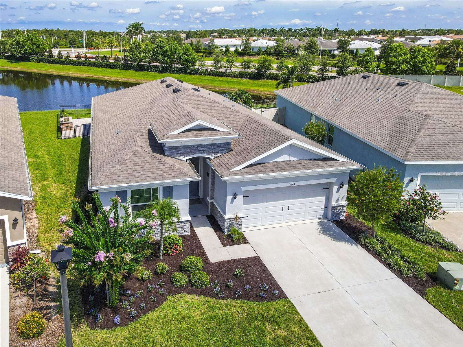 Welcome to Paradise in Solera at Lakewood Ranch! Step into your own private oasis—where the heart of the home extends outdoors to a beautifully designed backyard retreat. Enjoy tranquil pond views from the extended paver patio, complete with a custom paver bench, raised garden feature, and screened lanai perfect for morning coffee, evening wine, or weekend BBQs. This thoughtfully landscaped, fully fenced space is ideal for relaxing, entertaining, and enjoying the best of Florida’s indoor-outdoor lifestyle. Your furry friends will love this backyard too. Inside, this nearly new home—built in 2022—offers 3 bedrooms plus a den, 2.5 baths, and 2,772 square feet of bright and open living space. Located in the highly desirable Solera at Lakewood Ranch, the home seamlessly blends modern design with everyday comfort. The open-concept layout connects the kitchen, dining, and living areas, creating a welcoming and functional space for both daily living and gatherings. The kitchen features contemporary finishes, ample counter space, and a smart layout that makes cooking and entertaining a breeze. The primary suite is a peaceful haven, boasting a soaking tub, dual vanities, separate shower and two generously sized closets. Two additional bedrooms share a stylish full bath, while the fourth bedroom—currently used as a craft room—offers flexibility for a home office, nursery, or playroom. Ideally located near top-rated schools, scenic parks, walking trails, and shopping, this home delivers both convenience and lifestyle. As a resident of Solera at Lakewood Ranch, you'll also enjoy resort-style amenities including a clubhouse, pool, and playground—perfect for connecting with neighbors and enjoying Florida living to the fullest. Don’t miss your chance to own this slice of paradise in one of the country’s #1 premier master-planned communities.