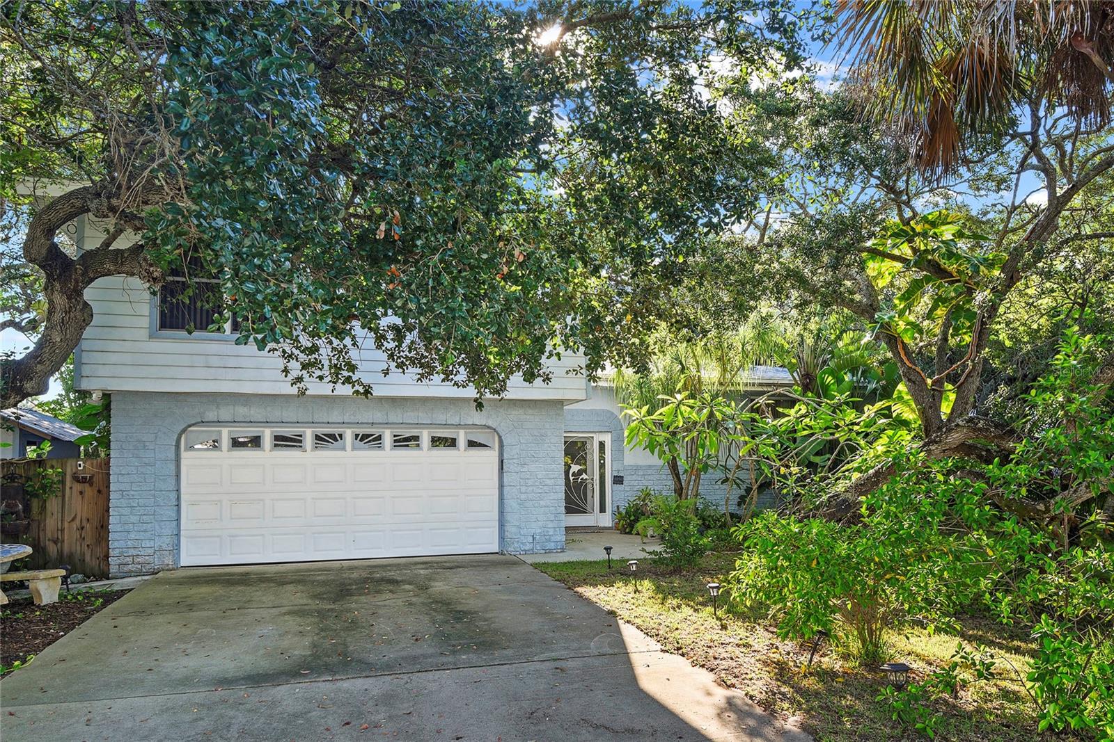 Nestled in the heart of North Beach—one of New Smyrna Beach’s most sought-after enclaves—this premier lot offers an extraordinary opportunity to reimagine coastal living. Set between the Atlantic Ocean and the Intracoastal Waterway, the property is surrounded by lush, mature trees and tropical foliage that provide both privacy and a serene natural backdrop. The existing 3-bedroom, 3-bath home—with potential for a 4th bedroom—features a two-car attached garage and an expansive rear balcony overlooking the verdant landscape. While the residence requires a full renovation, its setting is unparalleled, offering the perfect canvas for your dream beach retreat. Whether you envision a contemporary coastal haven or a charming seaside escape, this exceptional location places you just moments from the sand, surf, and all the lifestyle amenities that make New Smyrna Beach so desirable.