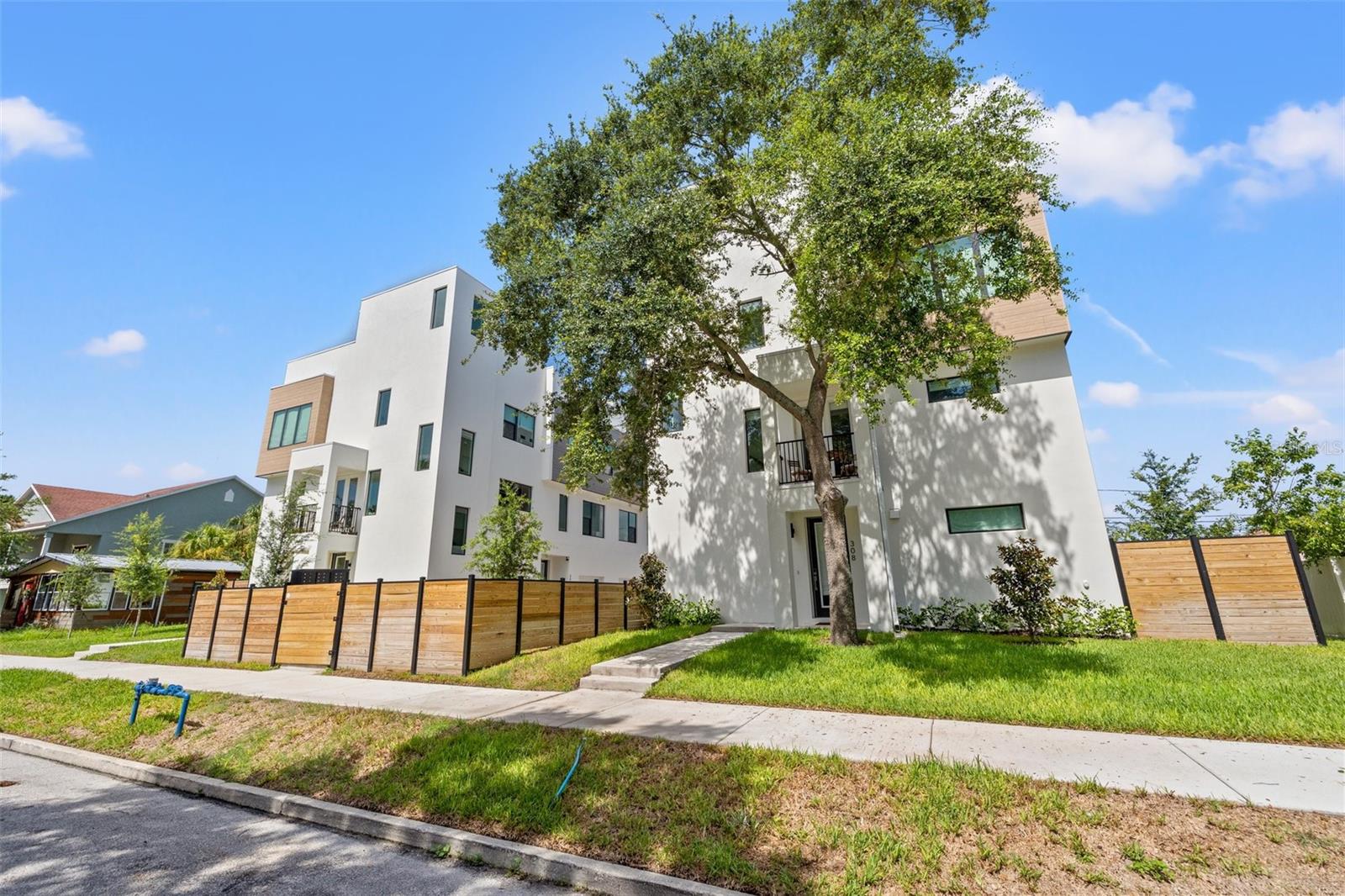 Step into a world of contemporary elegance with this brand-new townhome nestled in the vibrant heart of St. Petersburg, Florida. Designed for luxurious living, this exquisite residence boasts 3 spacious bedrooms and 3 and a half bathrooms with 2,070 square feet of living space -offering both comfort and sophistication. Enter through the inviting foyer to find a generously sized bedroom complete with a full ensuite bathroom. This space is perfect for guests or a private home office, featuring low-maintenance luxury vinyl plank (LVP) flooring that extends throughout the home, combining style with practicality. Ascend to the primary floor, where natural light floods an open floor plan designed for both everyday living and entertaining. The state-of-the-art kitchen is a culinary delight, equipped with top-of-the-line appliances, a sleek breakfast bar, Quartz countertops, and an elegant dining area. The adjoining living room provides a perfect space for relaxation and gatherings, while a conveniently located half bath adds to the functionality of this floor. The third floor is dedicated to the serene primary suite, featuring a spacious walk-in closet and a luxurious bathroom with dual sinks and a walk-in shower. A third bedroom, also generously proportioned, Washer & dryer, and a full bathroom complete this floor, offering ample space and convenience for family or guests. Unwind and entertain in style on your private rooftop oasis. With a wet bar conveniently located nearby, you can easily prepare your favorite beverages before stepping out to the wrap-around rooftop deck. This outdoor haven is perfect for soaking up the Florida sun by day and enjoying the stars by night, providing an unparalleled setting for relaxation and entertainment. Enjoy the best of St. Petersburg with this ideally located townhome, just 10 minutes from Tampa Bay Rays Stadium, 3 blocks from Central Ave and the vibrant downtown area. Revel in the proximity to the city's finest dining, speciality shopping, and cultural attractions, ensuring you are always at the center of the action. There's also a private 1-Car Garage to protect your vehicle from the sun and enjoy additional storage space with an epoxy-coated garage floor. New whole house water filtration system included. Water, trash, pest control, yard maintenance and security system included. A/C can also be controlled by wifi. Experience the pinnacle of modern living in this stunning new townhome while enjoying the vibrant culture of St. Petersburg.