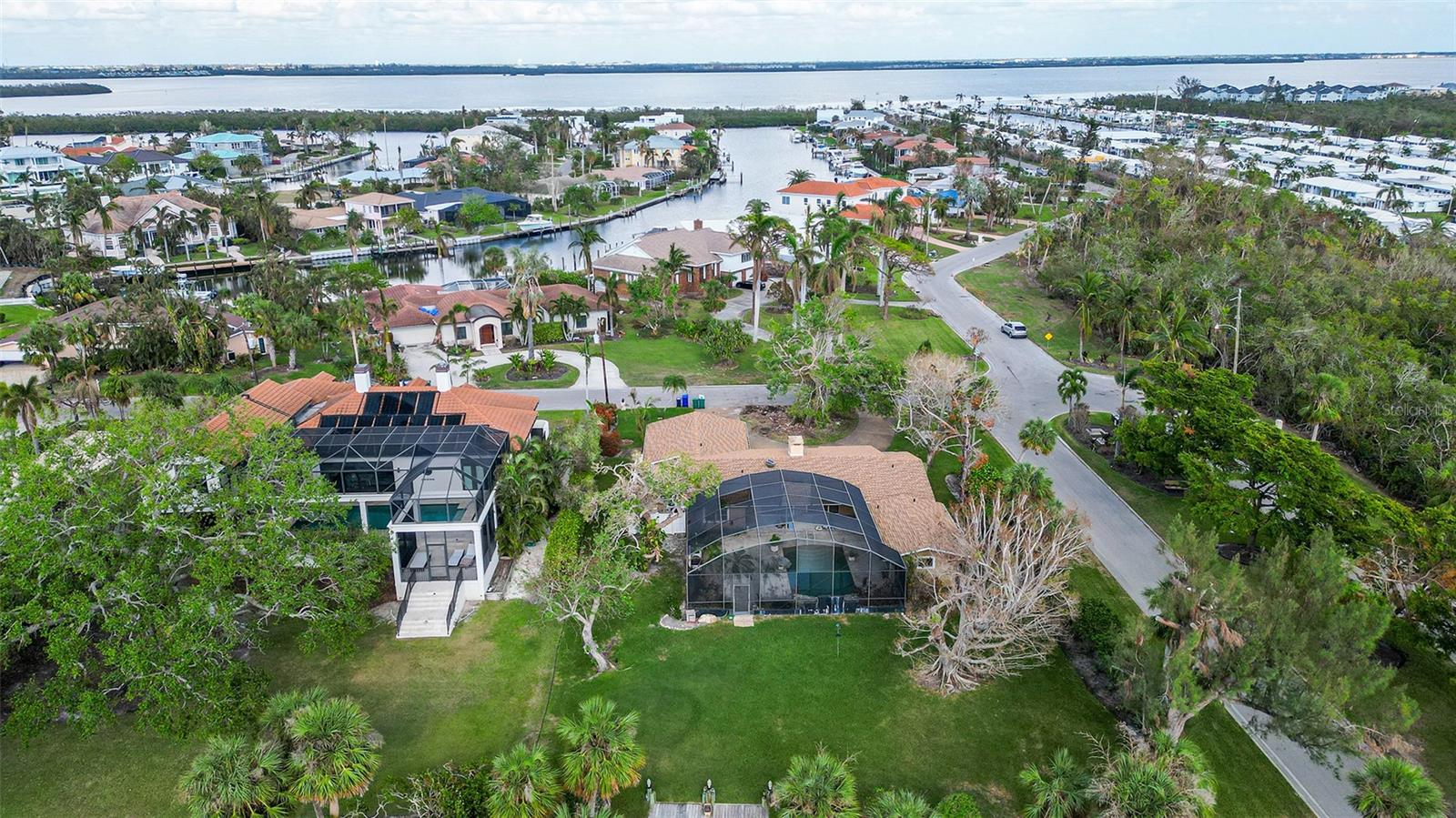 Coveted lifestyle and location on one of the widest deep water canals on Longboat Key with direct access to Sarasota Bay and inter- coastal waterway with no bridges! Great opportunity to remodel this 2 bedroom home with a separate guest house or build your special new home with a fantastic dock and location to the beach. The Emerald Harbor community has private beach access directly across the street. Special feature of this home is an inviting heated pool and large backyard area for family and friends to enjoy some of Florida's wildlife birds dolphins and manatees. The comfortable main sitting area looks out over the pool and wide canal. Emerald Harbor is a neighborhood comprised of 3 quiet streets. As a member of the voluntary Homeowners Association, you enjoy deeded beach access to the beautiful beach and warm Gulf waters on the shores of Longboat Key.