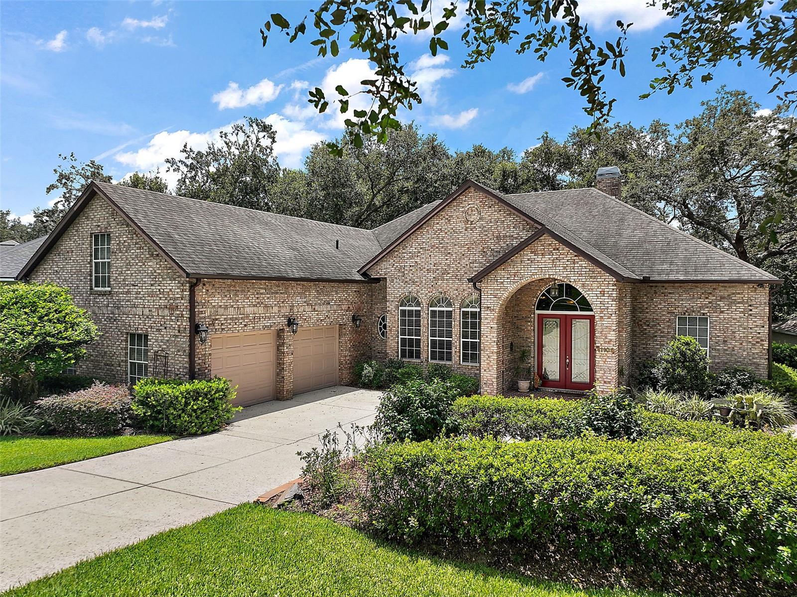 Welcome to this beautiful custom pool home in a small gated community located just minutes from all shopping and amenities in the rapidly growing city of Clermont. Outside you we'll see a circular driveway, a brick front exterior, beautiful 8 ft. cut glass double entry doors, and expertly maintained mature landscaping and trees. Once inside you will be amazed at the height of the ceilings, 8 ft. doors, the beautiful crown molding throughout the central living area, the custom engineered wood flooring, double sliding glass pocket doors leading to the pool deck area, and a wood burning fireplace in the living room. The over sized kitchen features granite countertops, center island, 42 in. cherry wood cabinets with beautiful crown molding, stainless appliances including a wall oven and a range, French door refrigerator, and an eat in countertop bar with pendant lighting, and a kitchen nook. The primary bedroom suite features a large bedroom with tray ceilings custom fans and double closets with built-in cabinetry. The fully remodeled primary bathroom has his and hers vanities, custom tiled walk-in shower, freestanding tub, and volume ceilings with crown molding. Back on the other side of the house you have a full pool bathroom with granite countertops and shower, two large bedrooms with double closets and crown molding and volume ceilings with a Jack and Jill bathroom with
granite countertops and beautiful tub shower combination. Upstairs is the fourth bedroom which can also serve as a large bonus room which is perfect for guest accommodations or recreational use. It features a full bathroom with granite countertops and walk-in shower plus a clothes closet. The inside laundry room has washer and dryer plus a utility sink. The oversized double garage has a workshop area with lots of storage. Out back on the pool deck you will find a beautiful view towards the pond, a fully screened enclosure, and outdoor kitchen with barbecue, ice maker, refrigerator and a salt water pool spa combination. At the rear of the house you will have access to the pond and that area leading to the pond is maintained by the community which is a bonus. The AC was replaced in 2017 and features four separate zones for maximum comfort. Roof in 2014. The septic system drain field was recently replaced. Washer and dryer are included. Don't miss out on a chance to see this beautiful custom home for yourself.