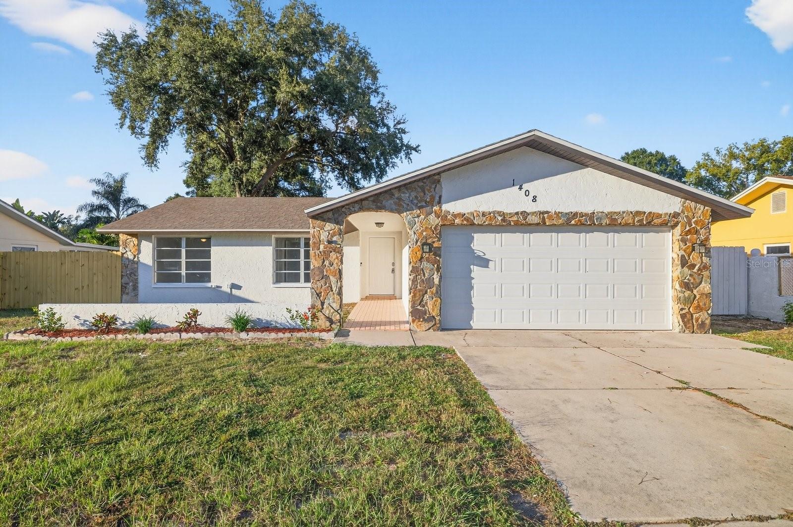 Welcome to 1408 Oleander Drive, a beautifully home located just minutes from historic downtown Tarpon Springs and the world-famous Sponge Docks. This stunning 3-bedroom, 2-bath residence has been completely updated inside and out, offering modern finishes, open-concept living, and a bright coastal feel throughout. Step inside to an airy living space with luxury vinyl plank flooring, fresh interior and exterior paint, and recessed lighting that creates a warm, inviting ambiance. The brand-new kitchen features sleek quartz countertops, soft-close shaker cabinets, backsplash, and stainless-steel appliances—perfect for cooking and entertaining. Outside, enjoy Florida living at its finest in the large wood fenced backyard, perfect for gatherings, pets, or adding a future pool. A newer roof for a great piece of mind and fresh landscaping to complete the picture, offering a move-in-ready home that blends comfort, style, and value. Located in a quiet neighborhood just minutes from top-rated schools, parks, and Gulf beaches, this home truly has it all!