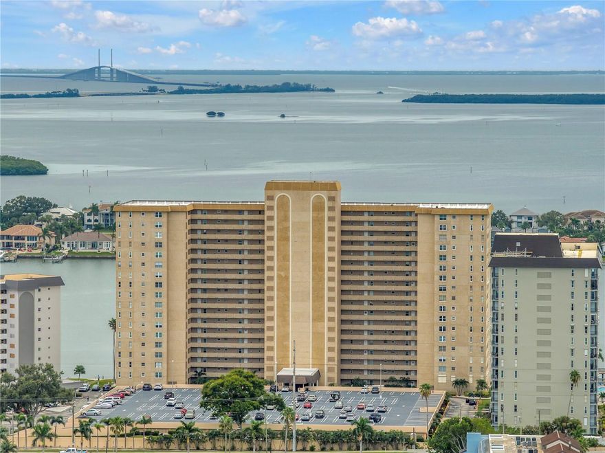 This 1700 sq. ft. 2 bedroom, 2 bath - with a bonus den/office - waterfront property offers you direct panoramic views of Boca Ciega Bay, the Gulf of Mexico, and the Skyway Bridge. The spacious open floor plan offers an abundance of natural sunlight, with water views from every window. Recently renovated, the entire condo has tile flooring, the updated kitchen features solid wood cabinetry, stainless steel appliances, granite countertops, a tile backsplash, a built-in desk, and a breakfast bar, and is open to the dining area and living room. The primary bedroom has dual closets and French doors that allow for sweeping waterfront views and open to a den/office. The ensuite bath features dual sinks, a walk-in shower, and granite countertops  The generous 2nd bedroom has a walk-in closet. There is a laundry closet with a stackable washer ad dryer, and a few doors down on the same floor there is a storage room with 2 large units dedicated to this condo. And most importantly....... a under-building garage space is included!
Point Brittany is a 55+ resort-like community with amenities such as 4 heated pools, a clubhouse, a fitness center, a spa, saunas, newly resurfaced tennis/pickleball courts, walking paths, a gazebo, pavilion, fire pit, bar-b-que areas, boat slips, fishing piers, kayak storage, yoga/dance studio, ballroom, arts and crafts studio, billiards, ping-pong, poker room, library, meeting and reception rooms. Come and enjoy the vacation lifestyle!