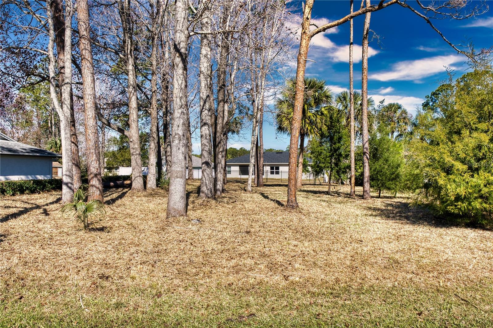 Discover a rare opportunity to build your dream home or expand your investment portfolio in Pine Lakes—one of Palm Coast’s most sought-after neighborhoods. This vacant lot can be purchased individually or bundled with the neighboring residence at 31 Woodholme Lane, offering incredible flexibility. Originally intended for a second home to generate rental income, the owners have already installed a fence gate that provides easy access to and from the existing property—ideal for multi-generational living or future rental possibilities. With convenient proximity to golf courses, shopping, dining, and the beautiful Florida coastline, this lot’s prime location ensures both comfort and value. Don’t miss out on securing your spot in Pine Lakes and tailoring it to your exact vision!