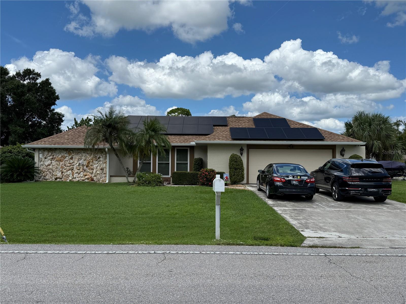 Spacious POOL HOME in Port Charlotte offers 3 Bedrooms, 2 Bathroom and attached 2 Car Garage. This light and bright home offers an open and split bedroom floor plan with Great Room, large Dining area, well appointed Kitchen, Inside Laundry and screened Lanai. The Great Room features a cathedral ceiling and sliding glass doors to the Lanai. The Kitchen offers white cabinetry, skylight, breakfast bar, pass thru to the Lanai and stainless appliances. Appliances include a French door refrigerator, dishwasher, oven/range, build in microwave. There is an Inside Laundry with washer, dryer, cabinets and laundry tub. The master bedroom suite offers lanai access, walk in closet and private bathroom with dual sinks and walk in shower. Note that the shower is wheelchair accessible. There are two generous guest bedrooms with double closets and the guest bathroom has dual sinks and a large walk in shower. Your living space extends to the screened lanai with large covered area, hot and cold outdoor shower, pocket sliders, inground pool with light and plenty of deck for sunbathing. Other features include: impact windows, hurricane garage doors, rain gutters, central vacuum. NEW ROOF 2023, New A/C 2017, new electric panel 2018, all new A/C ducts 6 years ago, NEW HWH 2 years ago. Solar panels provide power for the house. NO HOA. Utilities are county water and septic. This home is minutes from shopping, dining, medical care, waterfront parks, entertainment, Charlotte Sports Park and Charlotte County Fairgrounds.Furniture will be left for the buyer at no additional cost if the buyer wants it.