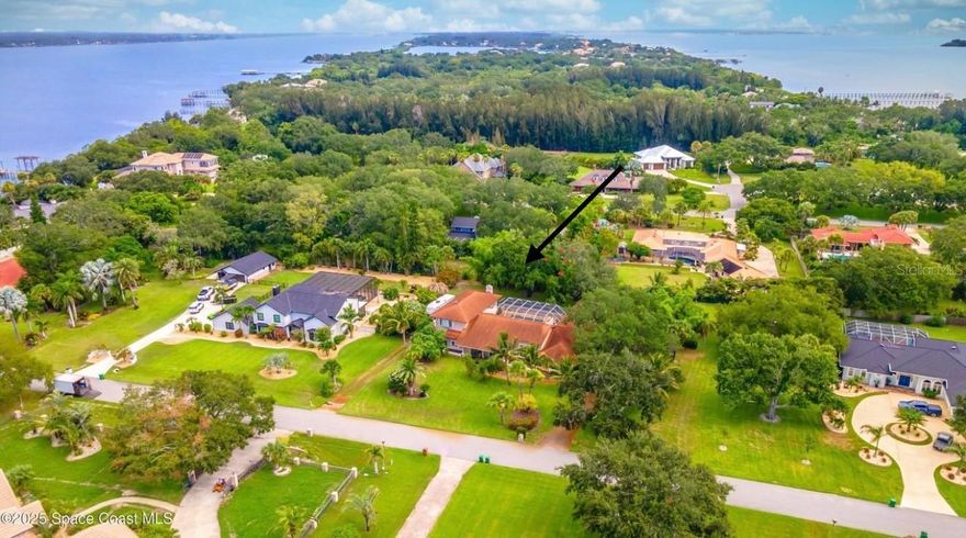 A Boater's Paradise, A Mechanic's Dream, and a Movie Lover's Escape. Step into a home that truly has it all—1 full acre of island living, where luxury, space, and lifestyle converge. Say goodbye to cookie-cutter homes and hello to your own private resort, complete with a four-car garage, RV space, a 8,000 lb boat lift and room to roam both inside and out. This 5-bedroom split floorplan is designed for both privacy and connection, with high coffered ceilings that elevate every space and three cozy fireplaces for year-round ambiance. The heart of the home is the gourmet kitchen, equipped for serious chefs and everyday entertainers alike—perfectly positioned for hosting or quiet nights in. The owner's retreat is your personal sanctuary, offering 900 sf of pure luxury, a private balcony, and a spa-worthy en suite bath. Outside, you'll find your very own resort-style oasis, featuring a heated pool, hot tub, and an outdoor bar, ideal for entertaining.
