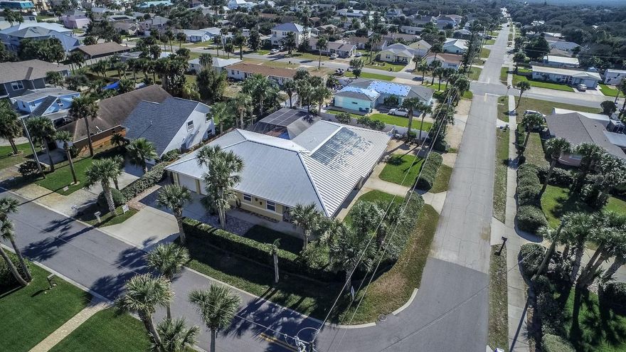 One of a kind home steps from the beach and centrally located. This unique home has the ability to be income producing, or a home for you and your family members. On your double oversized lot in the central beach area, you are minutes away form the ocean, the river, shopping on Flagler Avenue, and numerous restaurants just minutes away. Enjoy a completely private lushly landscaped backyard with your heated deep water pool. Enjoy the private views from multiple large Lanai. Utilities are available for your RV or boat from additional parking. Three large oversized garages will fit all of your toys. ;Water: City