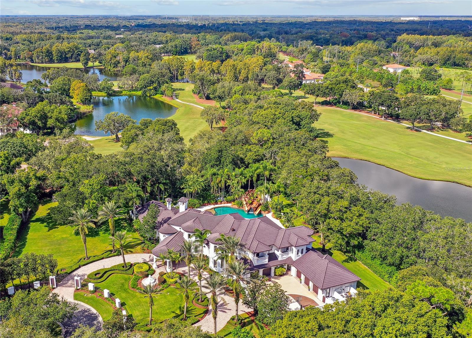 Villa Di Grotto, A true Mediterranean masterpiece in the prestigious Avila Golf & Country Club—Tampa Bay’s most exclusive and secluded guard-gated community. Originally commissioned by a legendary New York Yankees baseball player, this residence has been thoughtfully reimagined for today's luxury lifestyle, blending timeless architecture with modern sophistication. Set on a private estate lot in the heart of central Tampa, the home showcases meticulous craftsmanship, a grand double-height foyer, and exquisite designer finishes throughout.
The expansive floor plan offers elegant living and entertaining spaces, with a gourmet kitchen, luxurious primary suite, and beautifully appointed guest rooms. From the stone-carved fireplaces to the arched doorways and resort-style pool, every detail reflects a commitment to quality and refinement. Surrounded by serene landscaping and with access to world-class golf, tennis, and clubhouse amenities, this is a rare opportunity to own one of Avila’s most iconic residences.
