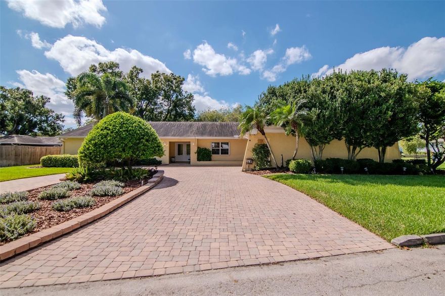 On a quiet street in West Riverside Heights sits a home that feels less like a listing and more like a family story — one carefully written by the same owner who built it for his loved ones in 1978 and tenderly preserved ever since. Location is the first chapter: this is truly one of Tampa’s best — 3 miles from the airport, 4 the shops and charm of Hyde Park, 6 miles to Downtown and close to River Walk,Water Street and Ybor. Whether your life moves by plane, play, or city nights, everything important is close at hand.
Step inside and the story turns modern. The interior has been fully reimagined with thoughtful, contemporary finishes while keeping the warmth of a home. New wood-plank tile runs underfoot guiding you to a kitchen that becomes the scene-stealer: a whopping 21' x 16' chef-sized space anchored by a large island, all-new solid wood cabinetry, quartz counters, and brand-new appliances — the kind of kitchen where holiday dinners and weekday spillovers both feel effortless.. French doors lead out to the large backyard. Outside, the plot is its own quiet subplot: a mature, thoughtfully planted landscape that feels intentional and private — a garden you could never buy off the shelf. Enjoy mornings beside the fountain, sip evenings on the patio while the yard hums gently with life, and appreciate how rare it is to find such an oversized lot in this pocket of Tampa. A paved roundabout driveway and two-car garage make comings and goings easy.
One of the home’s unique features is the attached in-law apartment. A large living room, kitchenette, and full bedroom and bath, it’s ideal for multigenerational living, long-term guests, or a private retreat for an adult child or parent. In short: a home this large, this upgraded, and this well cared for is a rare find, and it’s ready for its next family to add a few chapters of their own.