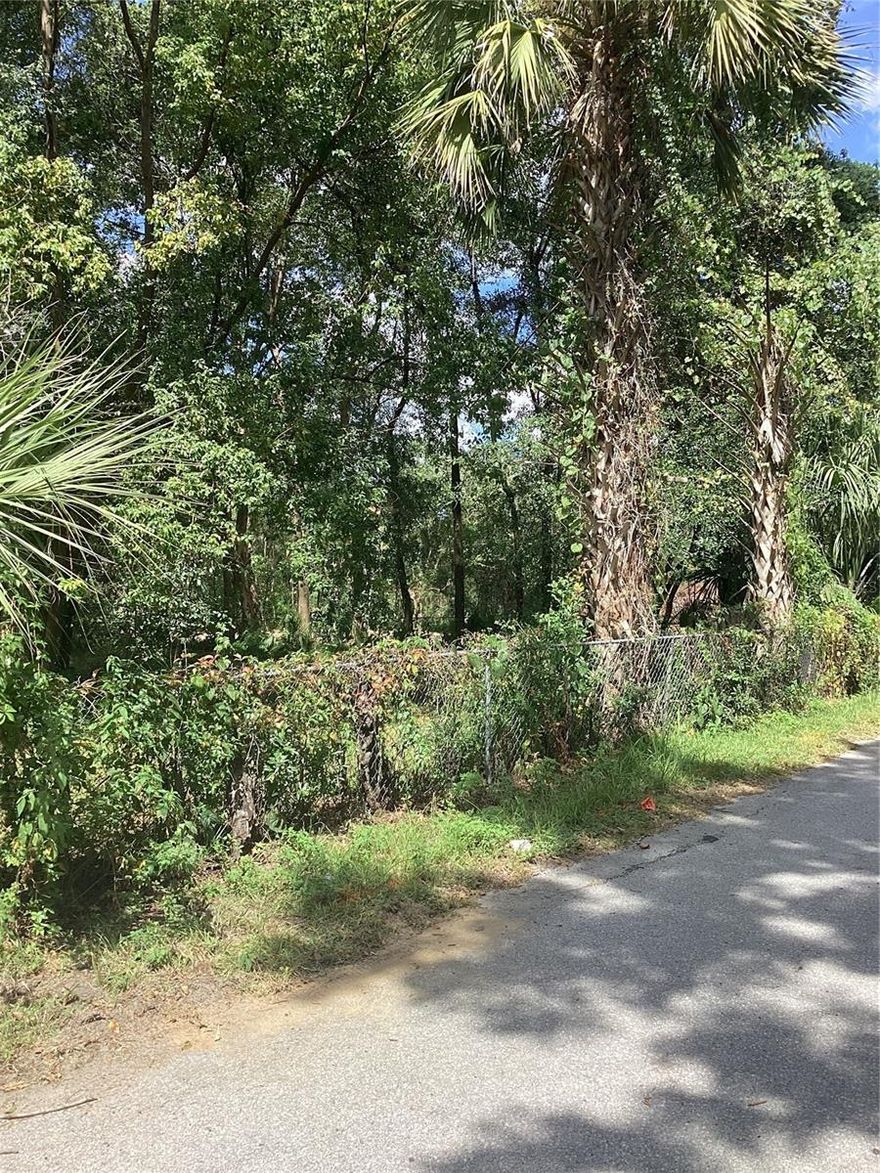 In the hot market of Florida real estate, we have a residential lot available in Ocala, FL with a chain-link fence. The lot is vacant and treed. In West Ocala, you’ll be a short drive from local stores and businesses, but the surrounding area is local residences, schools, and parks creating a small-town atmosphere. Centrally located by several interstates and I-75, travel will be a breeze. If you’re a nature enthusiast, Florida’s flora and fauna are short distance for you to explore like Ocala National Forest. There’s also state parks, springs, beaches, and islands that will be ideal for a day trip. Do you prefer your creature comforts? Don’t worry, Gainesville is less than a 45 minute drive. The zoning permits for a variety of uses including manufactured and stick built single family residences with ADUs and a gas station or country store. It is not within a flood hazard zone or wetlands. There’s approximately 80 feet of road frontage and 166 feet of depth. You’ll have access to public utilities at the street to get connected to.