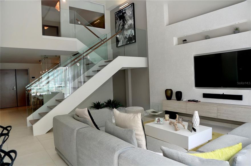 Fully Furnished Remodeled luxurious modern loft apartment in Condado (Prime Area of P. R.) at the Paseo Caribe multi condo complex. With 24/7 security, private gym, resident's lounge and an elite concierge service. Located steps away from Caribe Hilton, El Caribe Office Building, Escambron Beach and Luis Munoz Rivera Park. Apartment consists of 1 Master Bedroom with bathroom, Second Bedroom with Bathroom, a spacious living room/dining room with high ceiling, fully equipped kitchen with breakfast bar, laundry area, first floor full bathroom and balcony with a stunning view of the Condado lagoon. Apartment comes fully furnished. Paseo Caribe's first floor commercial area provides a unique lifestyle experience with handful of restaurants, bar, shops, hair salon, yoga salon and shared office spaces. This is truly a one stop shop experience.