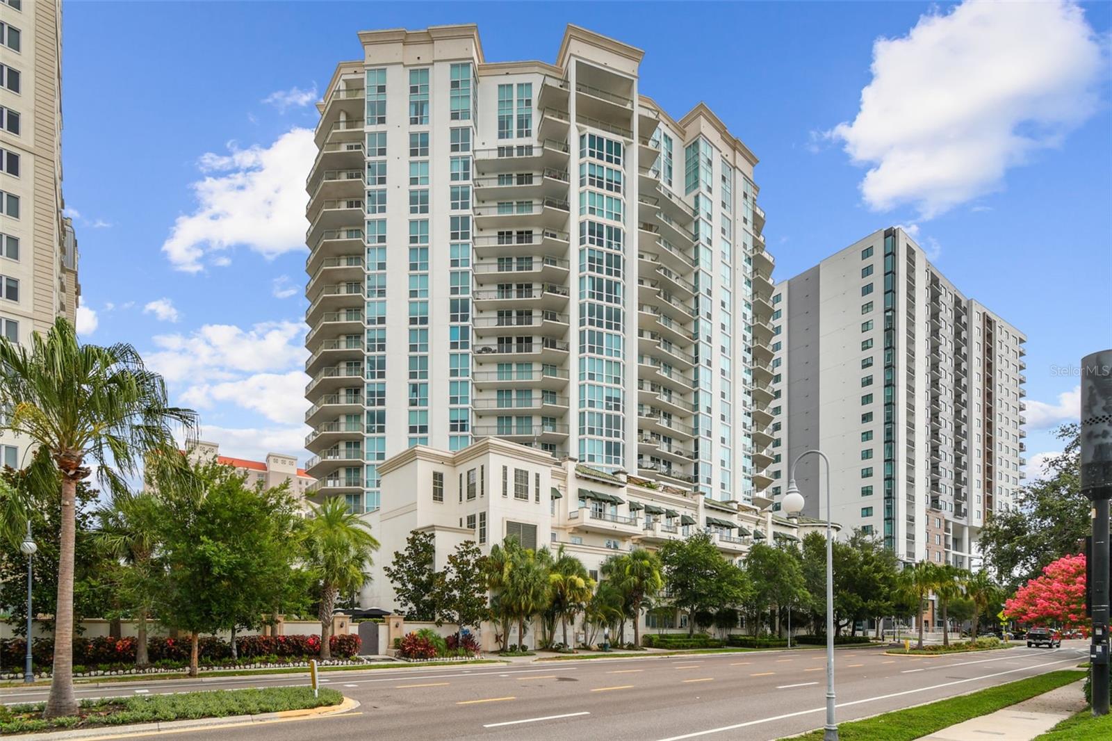 Poised atop the 20th floor of The Plaza, this extraordinary 3,980-square-foot penthouse is a masterclass in refined living. Thoughtfully reimagined in 2023, the residence blends impeccable craftsmanship with sweeping views—capturing the energy of downtown Tampa to the north and the serene beauty of Hillsborough Bay to the south. A private elevator opens to a dramatic marble foyer anchored by a crystal chandelier, leading into formal living and dining rooms adorned with custom millwork, archways, fireplace, and access to a private balcony with downtown water and skyline views. Rich wood and marble flooring, coffered ceilings, and detailed wainscoting underscore the residence’s elevated aesthetic. The chef’s kitchen is as functional as it is striking—featuring waterfall marble countertops, a Wolf 48" dual-fuel range, Sub-Zero appliances, dual dishwashers, farm and prep sinks, bar seating with under-counter storage, and ample space for both hosting and everyday living. A secondary living area offers a more intimate setting, complete with its own chandelier and access to a second balcony with bay views. The primary suite is a true retreat, framed by floor-to-ceiling windows and offering balcony access, a custom walk-in closet with island storage, and a spa-inspired bath with dual vanities, built-in dressing table, soaking tub, and a walk-in marble shower with four shower heads and body jets. Two additional bedrooms provide flexible accommodations—one with an en-suite bath, LED-lit vanity, walk-in closet, and tilt window; the other perfectly suited for use as a spacious office or guest room. A full laundry room with custom cabinetry adds everyday convenience. Additional features include a Brilliant Smart Home system, three deeded parking spaces (#229, #230, #107), and two climate-controlled storage units (#2 and #3). The Plaza’s renowned amenities include 24-hour concierge and valet, resort-style pool and spa with cabanas, fitness center, billiards room, guest suites, and meeting rooms. HOA includes internet, water, trash, security, insurance, recreational facilities, and more. This residence represents a rare opportunity to own a top-tier penthouse in one of Tampa’s most prestigious addresses.