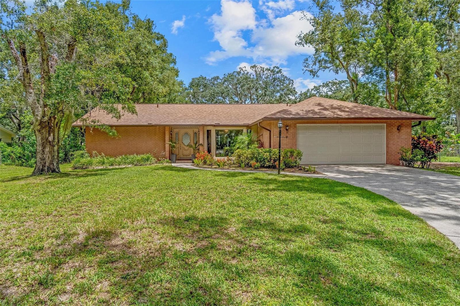 Endless possibilities await in this beautifully maintained 3-bedroom, 2-bath pool home with a 2-car garage, perfectly situated on an oversized lot! Step into the welcoming foyer and be immediately drawn in by the bright, open layout filled with natural light. The spacious living and dining areas flow seamlessly into a large kitchen and a cozy family room featuring a charming fireplace—ideal for hosting gatherings or enjoying quiet nights in. Each of the three bedrooms is generously sized, offering plenty of comfort and flexibility. The primary suite includes a walk-in closet and a private ensuite bath for your own peaceful retreat. Outside, your private oasis awaits—a stunning screened-in lanai opens up to an in-ground pool, perfect for relaxing or entertaining all year round. The expansive backyard also includes storage sheds for all your tools, toys, or hobbies. Unbeatable combination of space, functionality, and outdoor living, this is the dream home you’ve been searching for!