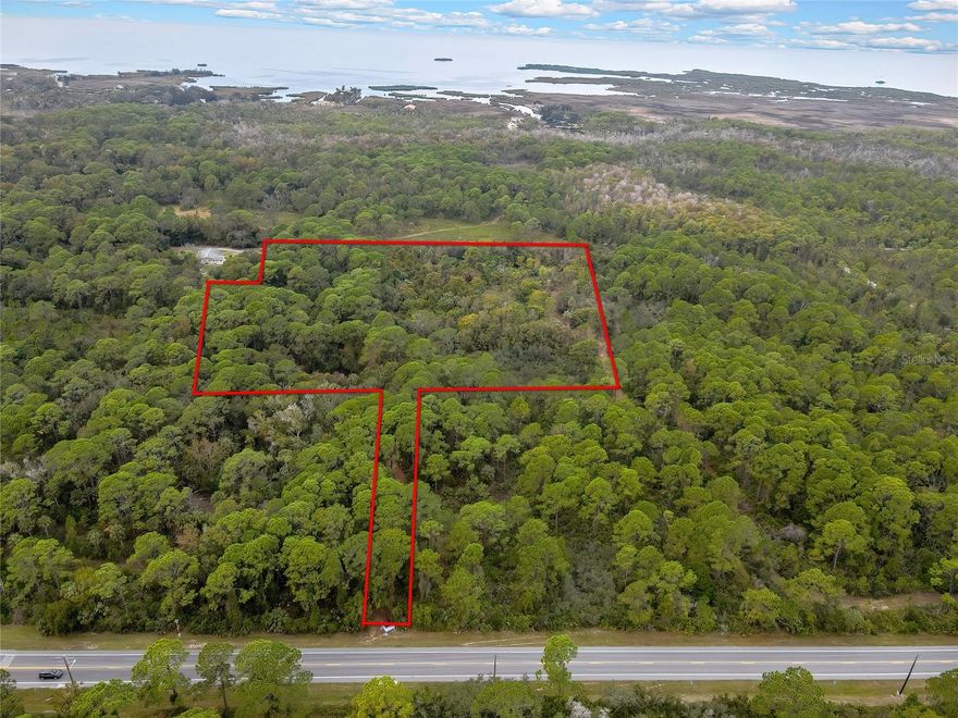 This exceptional 9.80acre parcel offers a rare combination of flexibility, development potential, and immediate access to Florida’s preserved lands—making it an ideal location for a premier hunting camp, outdoor retreat, or a small-scale residential subdivision. Zoned R-1A Residential, the property allows both conventional single-family homes and manufactured housing, giving buyers and developers, a wide range of options. The western boundary adjoins protected conservation land, ensuring permanent privacy, abundant wildlife corridors, and year-round hunting and wildlife watching opportunities right from your back door. With a minimum lot size of just 6,000 sq. ft., this land can easily be subdivided into multiple home sites, making it highly appealing for residential development or maintained as a private
hunting compound. The property is accessed via a 20foot easement from Shoal Line Boulevard, providing a comfortable setback from the roadway while maintaining convenient accessibility. This offering encompasses two parcels—Key Number 374473 (4.00 acres) and Key Number 374428 (5.80 acres)—sold together for a total of 9.80 acres. R-1A zoning permits accessory uses such as garages, carports, and outbuildings that are perfect for equipment storage, game processing facilities, bunk cabins, or workshops. Special exceptions are available for home occupations and bed and breakfast establishments, and favorable dimensional standards, including modest setbacks and a minimum dwelling size of only 600 sq. ft., further enhance design flexibility for creating a rustic camp, sportsman’s
enclave, or a cluster of custom homes. Adding practical convenience, Hernando County records show a plan for a general store located
across Shoal Line Boulevard from the parcel. Picture a thoughtfully designed country store and outfitters hub steps from your gate—serving camp guests, nearby residents, and outdoor enthusiasts with supplies, bait and tackle, local provisions, and a community gathering spot after a day in the field or on the water. Having a store so close elevates the property’s appeal as a turnkey hunting camp or weekend retreat and supports blended uses that enhance revenue and guest experience. The parcel sits in the Weeki Wachee area, home to some of Hernando County’s most treasured parks. Just minutes away are Alfred McKethan Pine Island Park, Bayport Park, Jenkins Creek
Park, and Linda Pedersen Park where residents can enjoy beaches, boating, fishing, boardwalks, and manatee viewing. This unique combination of preserved land access for hunting, nearby worldclass fishing, and close by commercial convenience creates an outdoor
enthusiast’s dream property. Whether you are a developer looking to maximize the land’s potential, a hunter seeking private access to protected game lands, or an entrepreneur building an off-grid retreat with a community hub, this 9.80acre parcel is a rare find where Florida’s wild beauty meets practical opportunity.