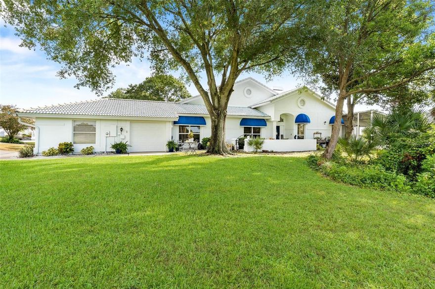 KING OF THE HILL...SPECTACULAR HOME! Enjoy amazing GOLFCOURSE AND LAKEVIEWS...feels like your own treehouse! This "ONE OF A KIND" end unit, spacious townhome/villa with durable construction to include a firewall on quiet cul-de-sac...Walk to the clubhouse, watch the golfers tee off right out your window or enjoy gazing from your screened lanai overlooking Lake Griffin! FABULOUS SUNRISES! Completely remodeled with upgrades, interior painted, new flooring and redesigned...Enter into "your castle" through the courtyard with iron gate which is highly elevated above the trees below leading you into a home your guests will never forget! Great room with volume/tray ceilings with crown molding plus custom wet bar leading you to your sunroom relaxation area! Formal dining room with custom storage & shelving. Kitchen that is "fit for a chef" features cabinets galore & new granite countertops plus all new "Energy Star" appliances to include 5 burner smooth top range, built in microwave, "French Style" side/side refrigerator and dishwasher! Pendant lighting over snack bar opens to large breakfast area. Oversized Master suite with vaulted ceiling features private walled courtyard with exterior personal private iron gate entrance. Renovated bathroom with walk in closet for the Mrs. & separate mirrored wall closet for the Mr... free standing tub for your "bubble bath" relaxation, raised vanity with dual above bowl sink basins plus separate glass walk in shower with rain shower head and body jets! Home has all new lighting, fixtures & fans throughout! Bedroom 2 & potential 3rd bedroom used as office features dual pocket door access share the renovated guest bath that features a new circular modern shower with rain head & body jets, raised vanity with above bowl sink! Whole house water filtration added & electric re done year 2021 plus new window screens! Extra deep garage with new garage door year 2020 & added keypad to golf cart garage! Take advantage of MAINTANENCE FREE living.... exterior of home from outside walls, roof repairs (NEW ROOF IN MAY 2026), lawn water/irrigation plus complete yard care included in HOA! Newly landscaped plus added gutters/gutter screens. Enjoy the "feeling of security" & peaceful living here in this manned guard gated 24/7 golf community with close proximity to The Villages and area shopping. Clubhouse social and Golf memberships available for a separate fee! You won't go wrong with this one...bring your Queen and call this "HOME SWEET HOME"!