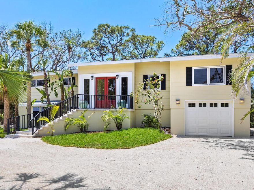 Welcome to the Sanderling Club, one of Siesta Key’s exclusive and sought-after neighborhoods, offering luxury living in the heart of paradise. As the island’s only gated single-family home community with 24-hour staffed security, Sanderling Club is renowned for its breathtaking beachfront properties, lush landscapes and outstanding amenities. This unique property offers two separate residences, with new roofs and exterior paint, and includes a combined four bedrooms, four bathrooms and 3,766 square feet of refined living space, including additional non-conforming living areas. Among grand live oaks and overlooking the waters of the Heron Lagoon with a combined nearly 50 acres of tranquil waters — a kayak enthusiast’s dream — the home is designed to embrace natural beauty that surrounds it. The main residence was originally built in 1960 and completely remodeled in 2010, featuring beautiful, polished travertine floors, soaring vaulted ceilings with skylights that illuminate the main living areas, and custom built-ins throughout. A modern chef’s kitchen showcases rich-toned cabinetry, stone countertops, a five-burner gas cooktop, built-in stainless steel ovens and refrigerator, a spacious pantry, and a large laundry room with built-in desk and ample storage. This home also features an open-concept den with built-ins. The dining room, wrapped in a wall of impact glass windows with lanai access, creates an ideal space for casual living and elegant entertaining. The private owner’s/primary suite occupies the entire upper level, offering an en-suite bath, private viewing deck, custom built-in bamboo cabinetry and convenient access to the guest house/in-law suite. The ground level includes a bedroom, bath, flex room with kitchenette, and an air-conditioned one-car garage with new epoxy-coated floors and 13-by-21-foot loft storage space. The guest house, with elevator access, was built in 2008 and features a combined living room and kitchen space, two bedrooms, a full bath, laundry facilities, two-car garage with additional storage and expansive decks overlooking the tropical landscaped backyard and Heron Lagoon waters — the ideal retreat for guests or extended family. The expansive backyard offers space to create your tropical oasis, with room for a pool and spa. Sanderling Club’s premier amenities include new Har-Tru tennis courts, pickleball, playground and a newly remodeled clubhouse (coming soon). Boat slips, when available, offer direct access to Sarasota Bay, the Intracoastal Waterway and the Gulf. All of this is just minutes from Siesta Key’s world-famous crystal quartz sand beaches and the charming shops and restaurants of Siesta Village. Plus, downtown Sarasota’s vibrant arts and culture scene — with its theaters, ballet, opera, museums, galleries and shopping — is just a short drive away. Don’t miss this rare opportunity to experience the best of coastal luxury living on Siesta Key.