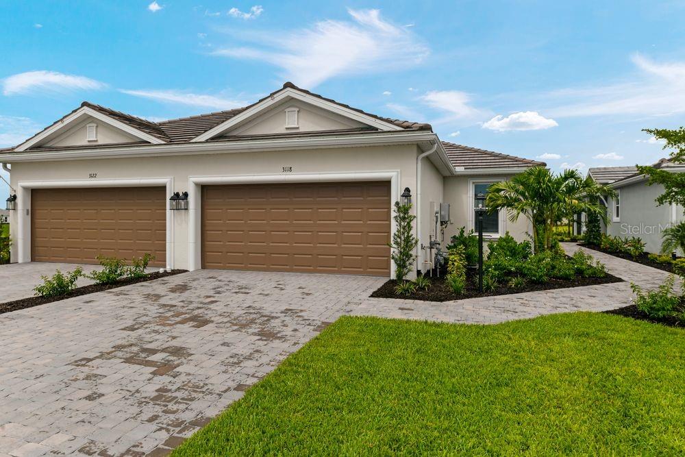 New Construction - Ready Now! Built by Taylor Morrison, America's Most Trusted Homebuilder. Welcome to the Ibis at 3118 Torta Court in Esplanade at Azario Lakewood Ranch. The Ibis Twin Villa offers a fresh take on open-concept living with 1,533 square feet of thoughtfully designed space. This 2-bedroom, 2-bathroom layout includes a flexible front room—ideal for a home office or guest space—plus a 2-car garage and plenty of thoughtful touches throughout. The elegant primary suite feels like a private retreat with its generous walk-in closet, dual vanities, large shower, and enclosed commode. The secondary bedroom and flex space are positioned near the front entry for added privacy, while the heart of the home brings everyone together in the spacious great room, designer kitchen, and separate dining area. A screened lanai extends your living space outdoors, perfect for laid-back evenings or casual get-togethers. Discover the charm of the Ibis in Esplanade at Azario Lakewood Ranch—a vibrant community you’ll love to call home. Additional Highlights Include: Study and Extended Outdoor Living. MLS#A4651990
Resort-Style Living at Esplanade at Azario Lakewood Ranch, the perfect blend of relaxation and recreation! Enjoy the heated resort-style pool, state-of-the-art fitness center, and energizing aerobics classes. For outdoor enthusiasts, there are pickleball courts, scenic trails, Vitality Park, and if golf is your game, you'll love Esplanade's 18-hole championship course! Unwind with a facial massage or by the fire pit after a workout. Exclusive amenities like a Wellness Center, Culinary Center, and sports courts ensure there's something for everyone, whether you want to stay active or relax in style.